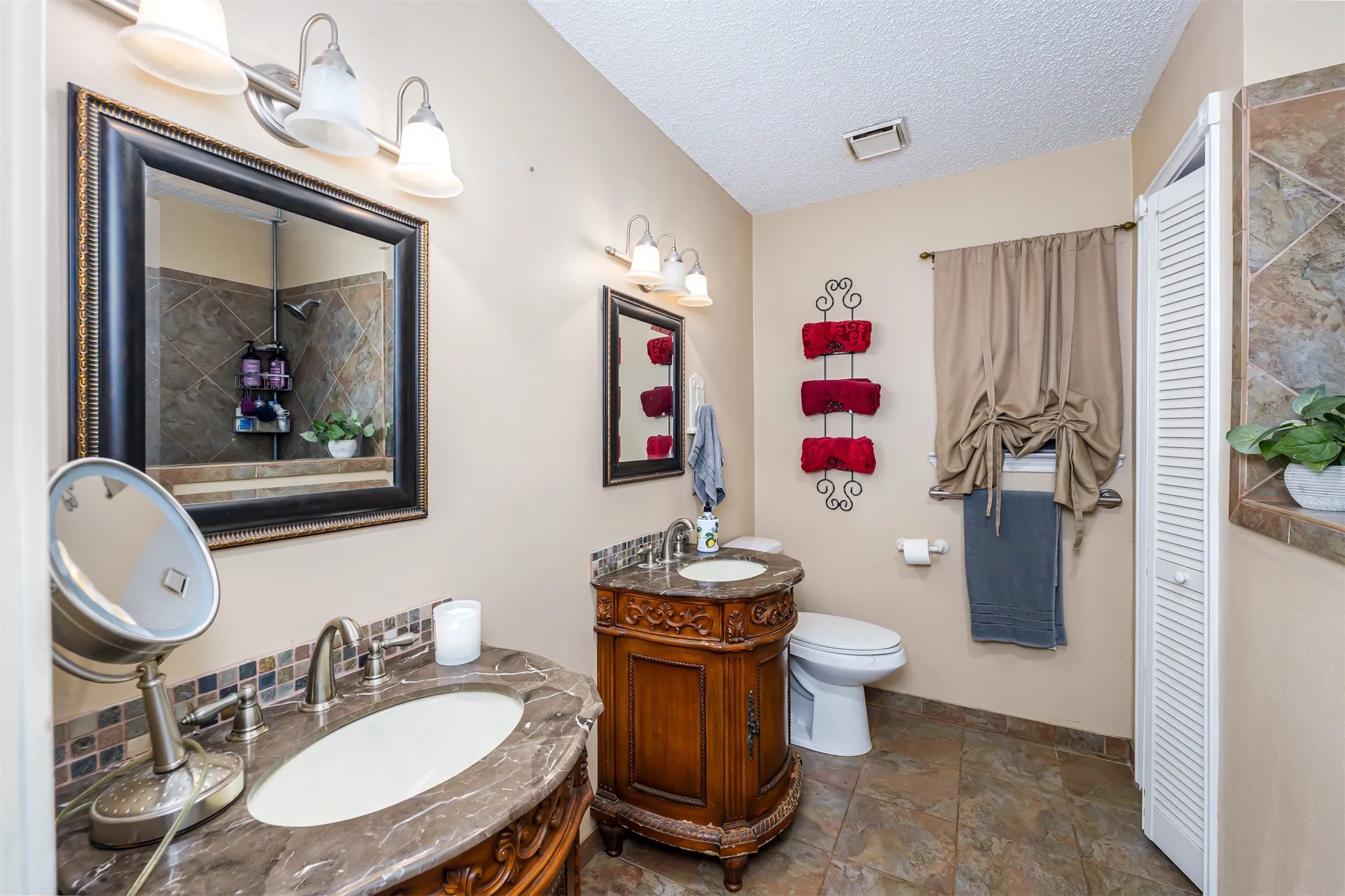 Dual vanity sinks with ornate wood-finish cabinetry