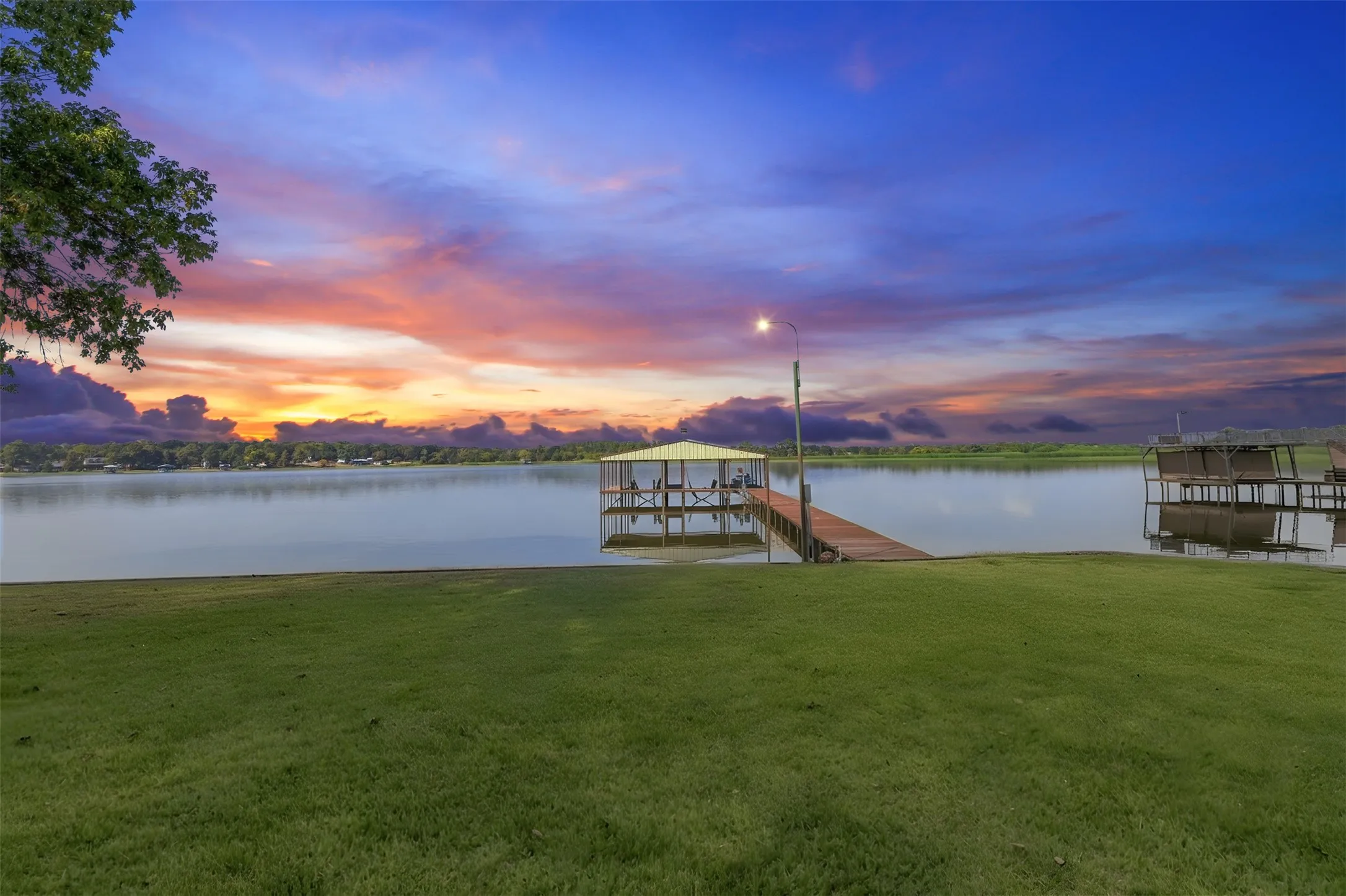 Expansive green lawn with direct waterfront access