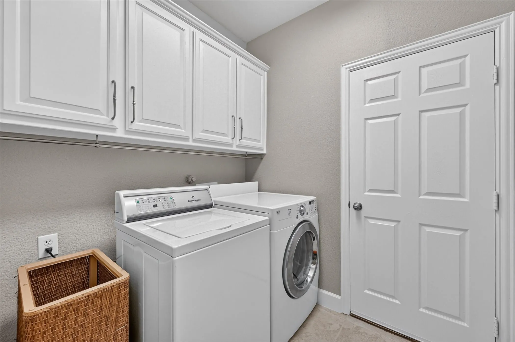 The laundry room has custom built-in cabinets