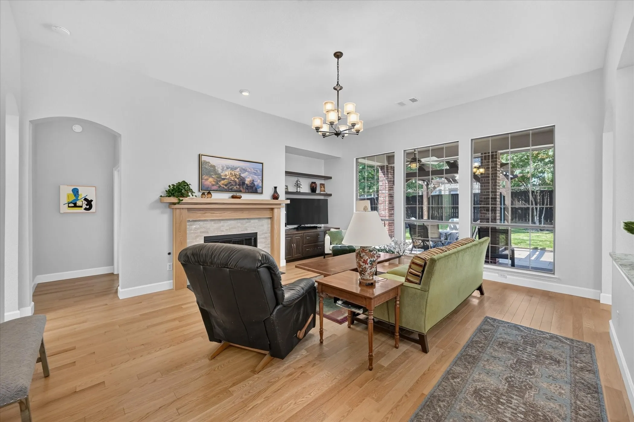The large windows bring the outside in and offer a beautiful view of the covered expansive patio