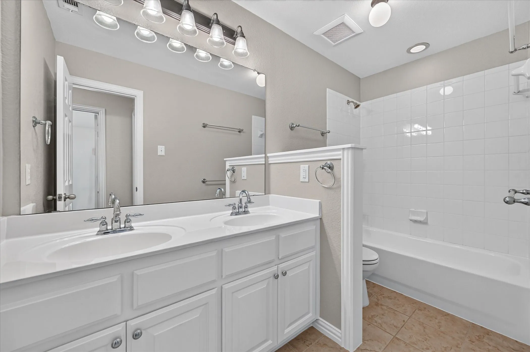 This hall bath serves two of the updatairs bedrooms, and has generous cabinet space