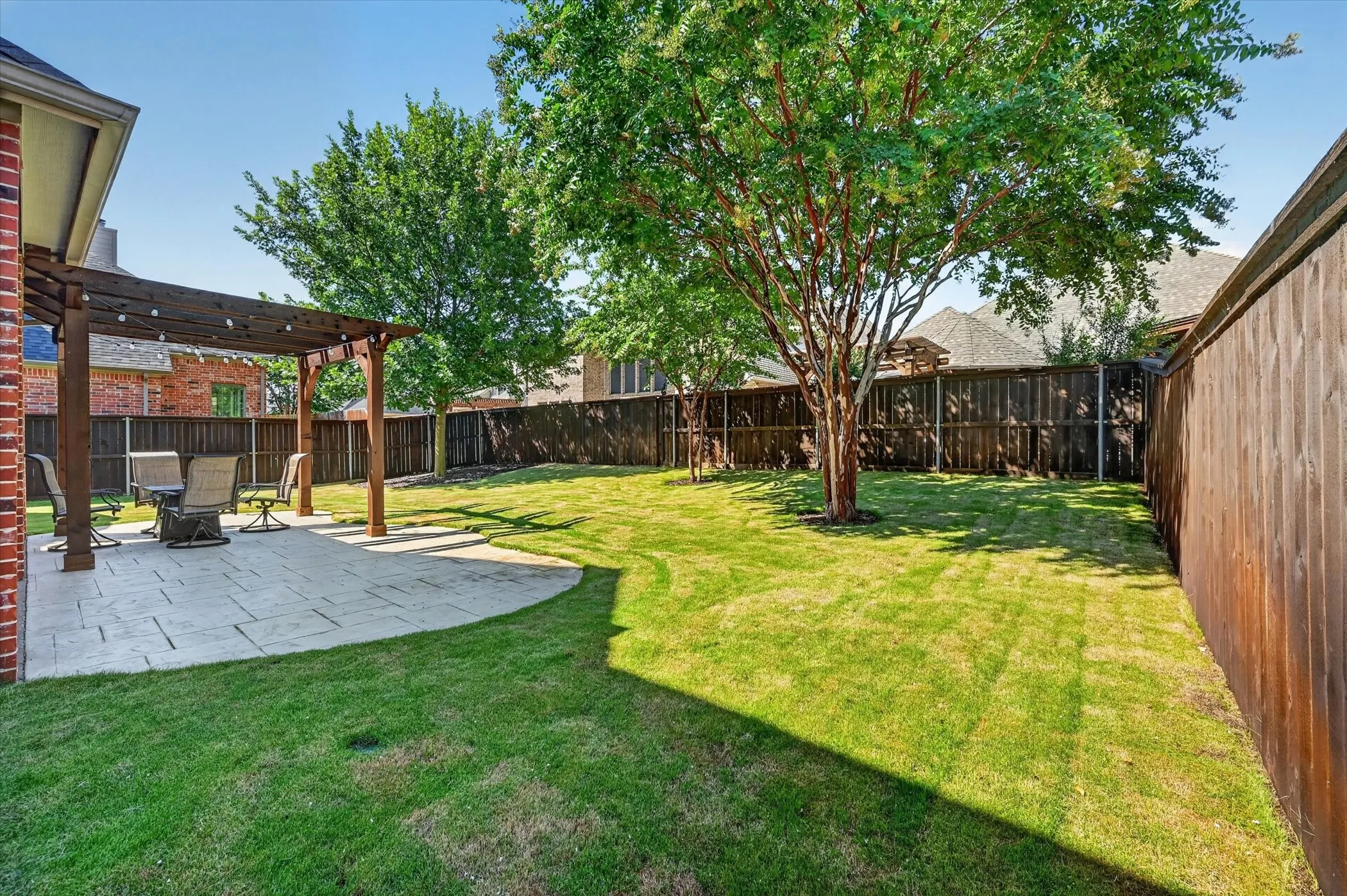 Wood privacy fences enclose the back yard