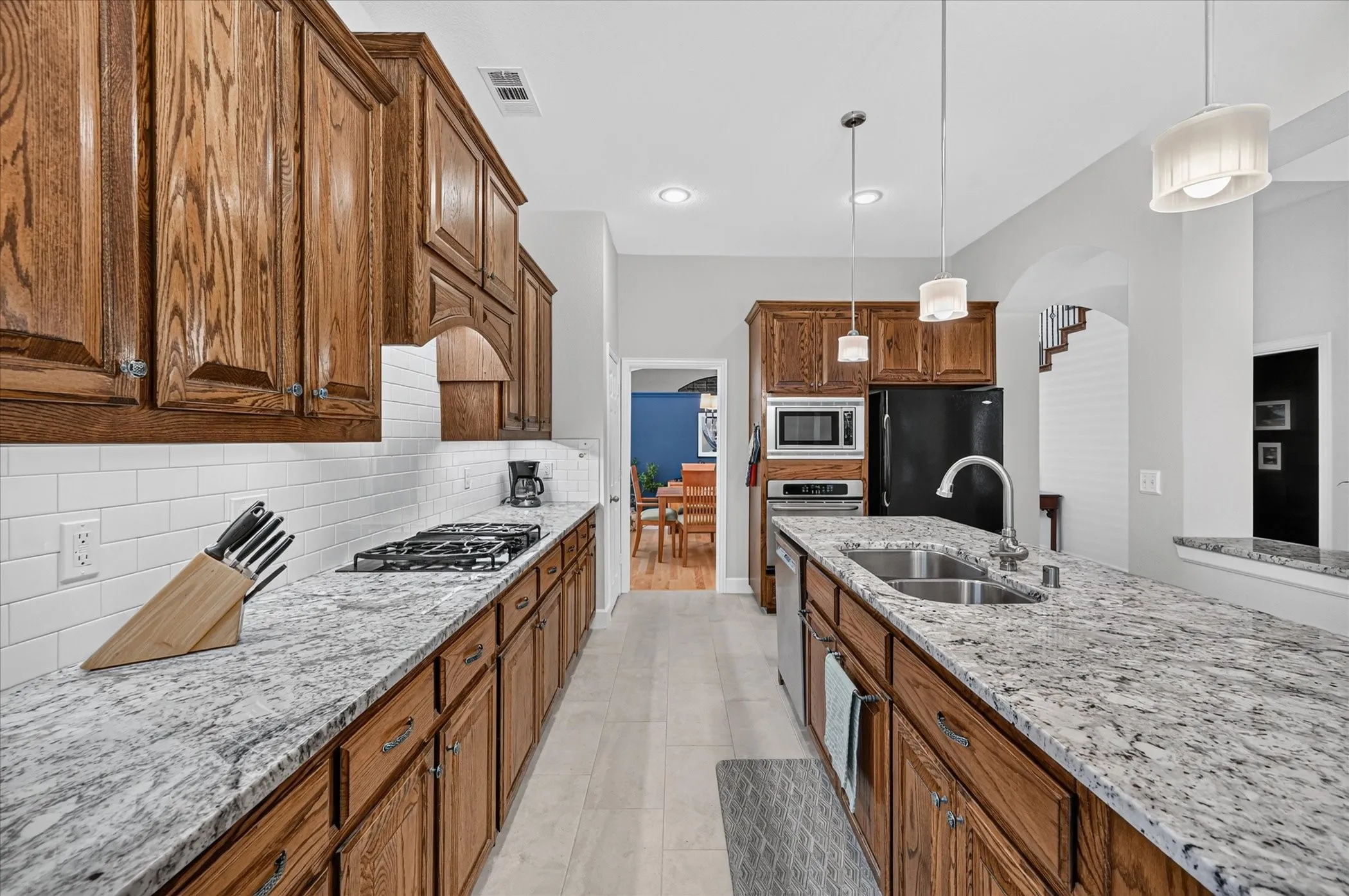 Stylish subway tile backspash and custom wood vent hood