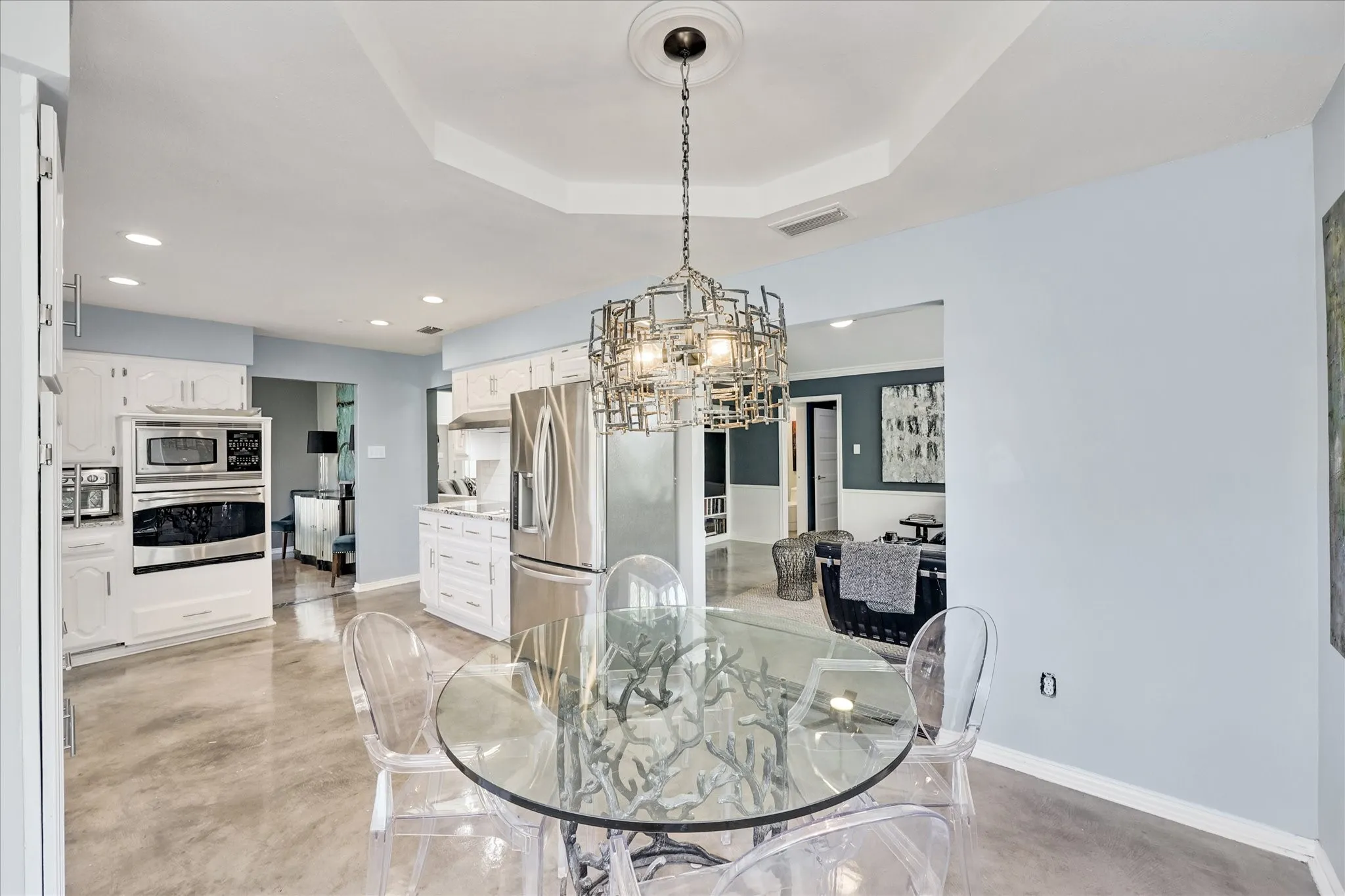Ceiling fan with brushed nickel finish, recessed lighting, white trim, and a barn door with frosted glass panels