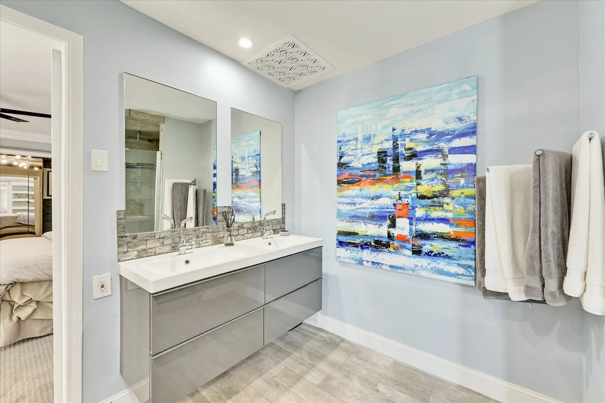 Glass-enclosed shower with a geometric tile band and built-in niche