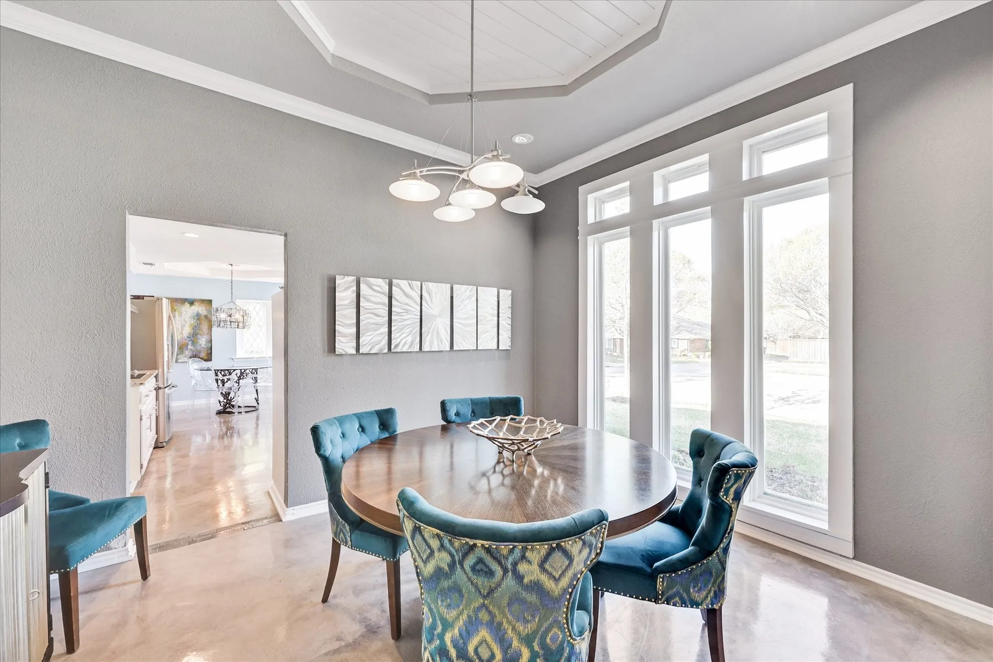 Kitchen featuring white cabinetry, subway tile backsplash, stainless steel appliances, granite countertops, and polished concrete flooring