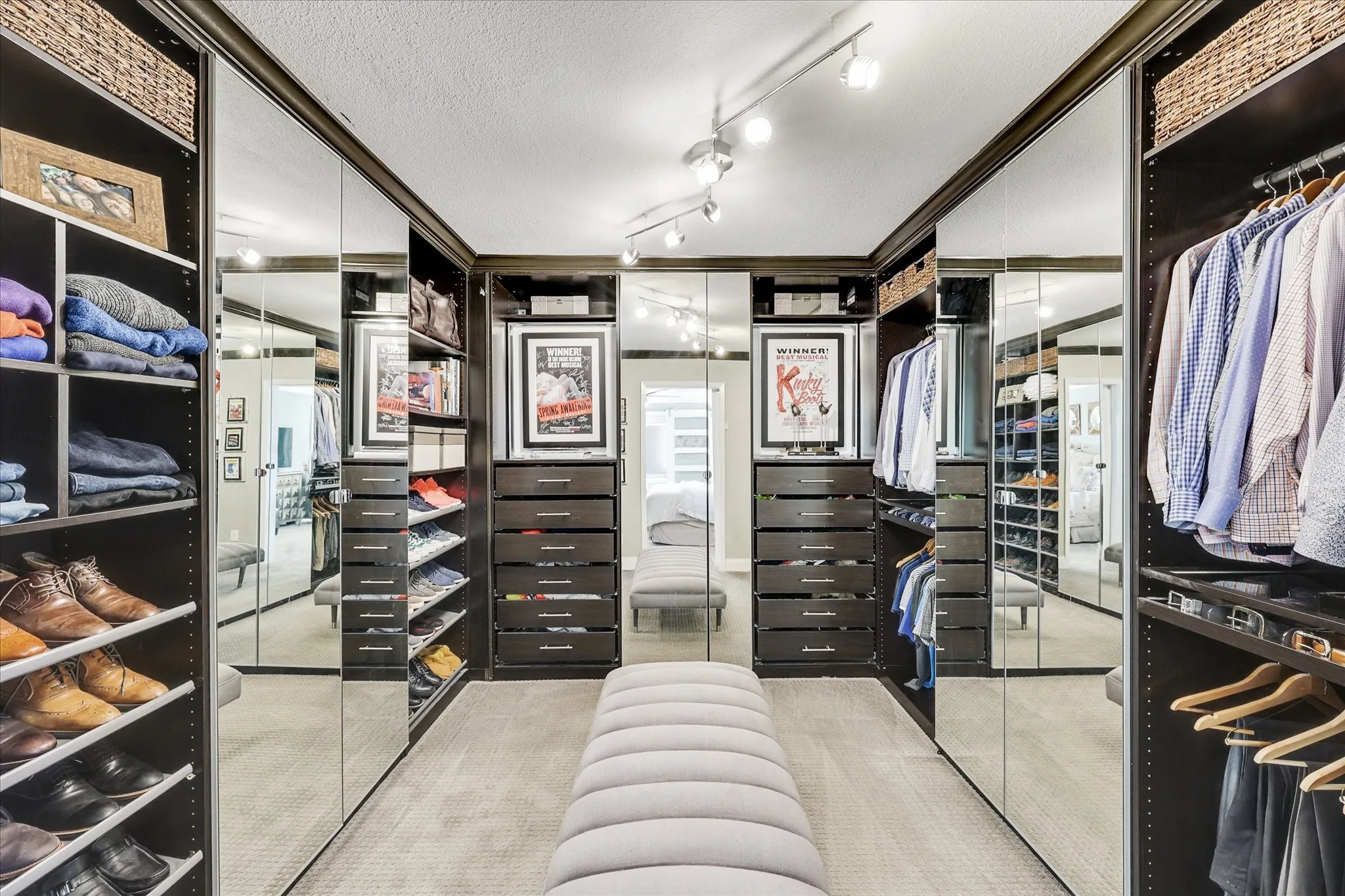 White cabinetry with silver-tone hardware, window with blinds, and built-in shelving