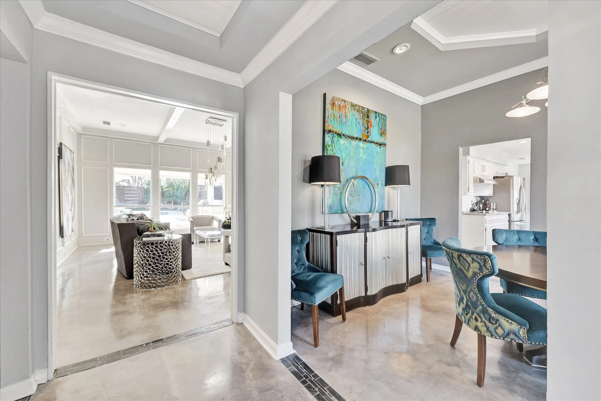 Expansive living space featuring a contemporary fireplace, floor-to-ceiling windows, and a built-in wet bar