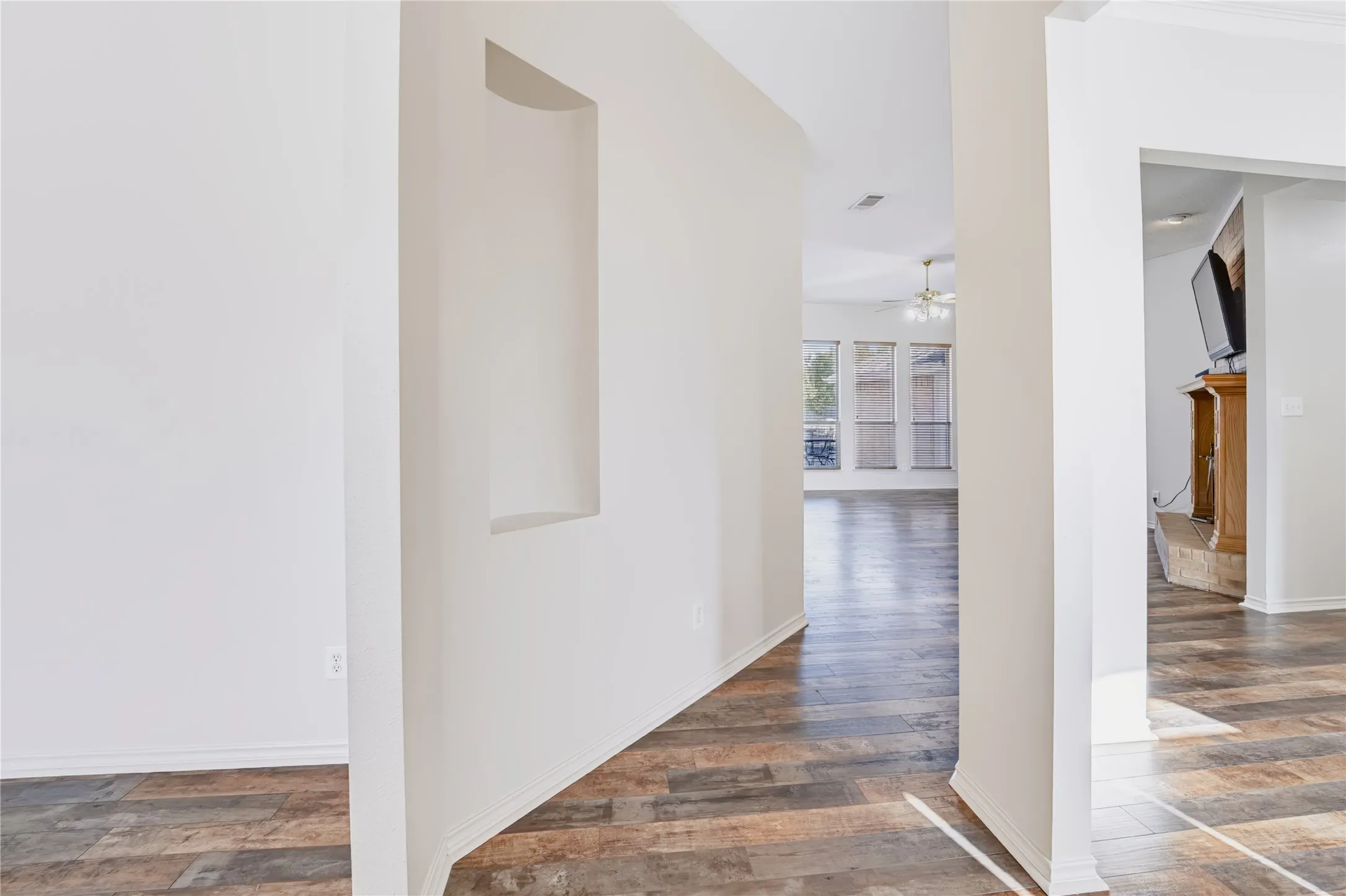 Interior featuring wood-finish flooring, a recessed wall niche, and a neutral color palette