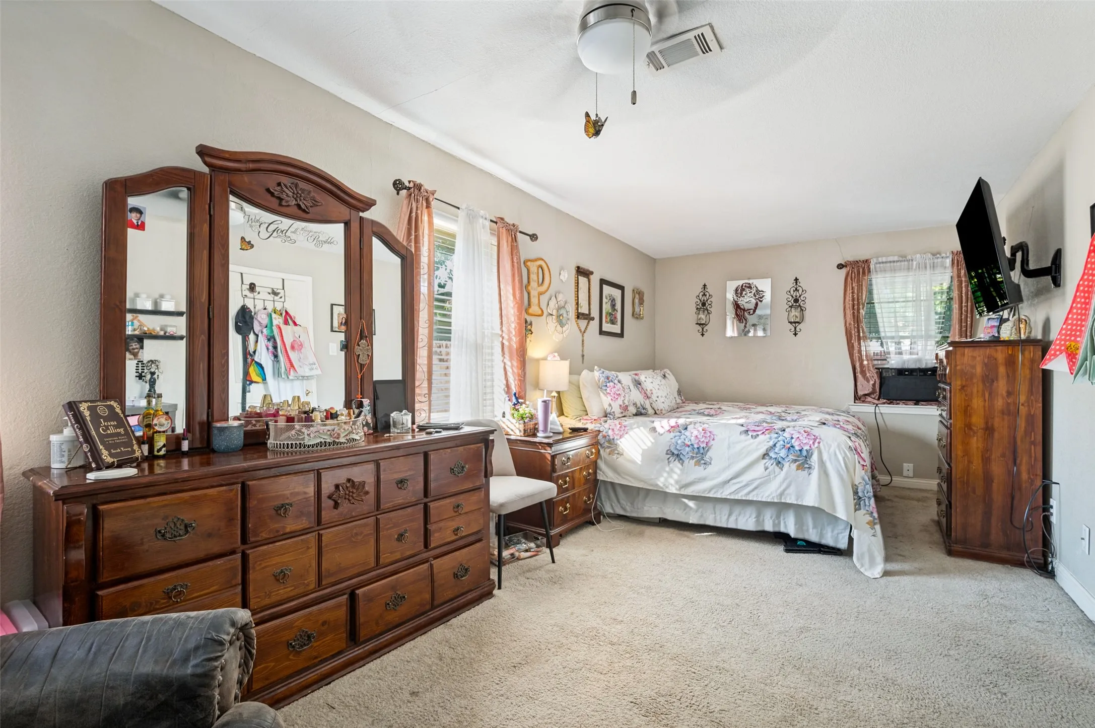 Neutral wall paint, ceiling fan with integrated lighting, carpeted flooring, and a window with blinds