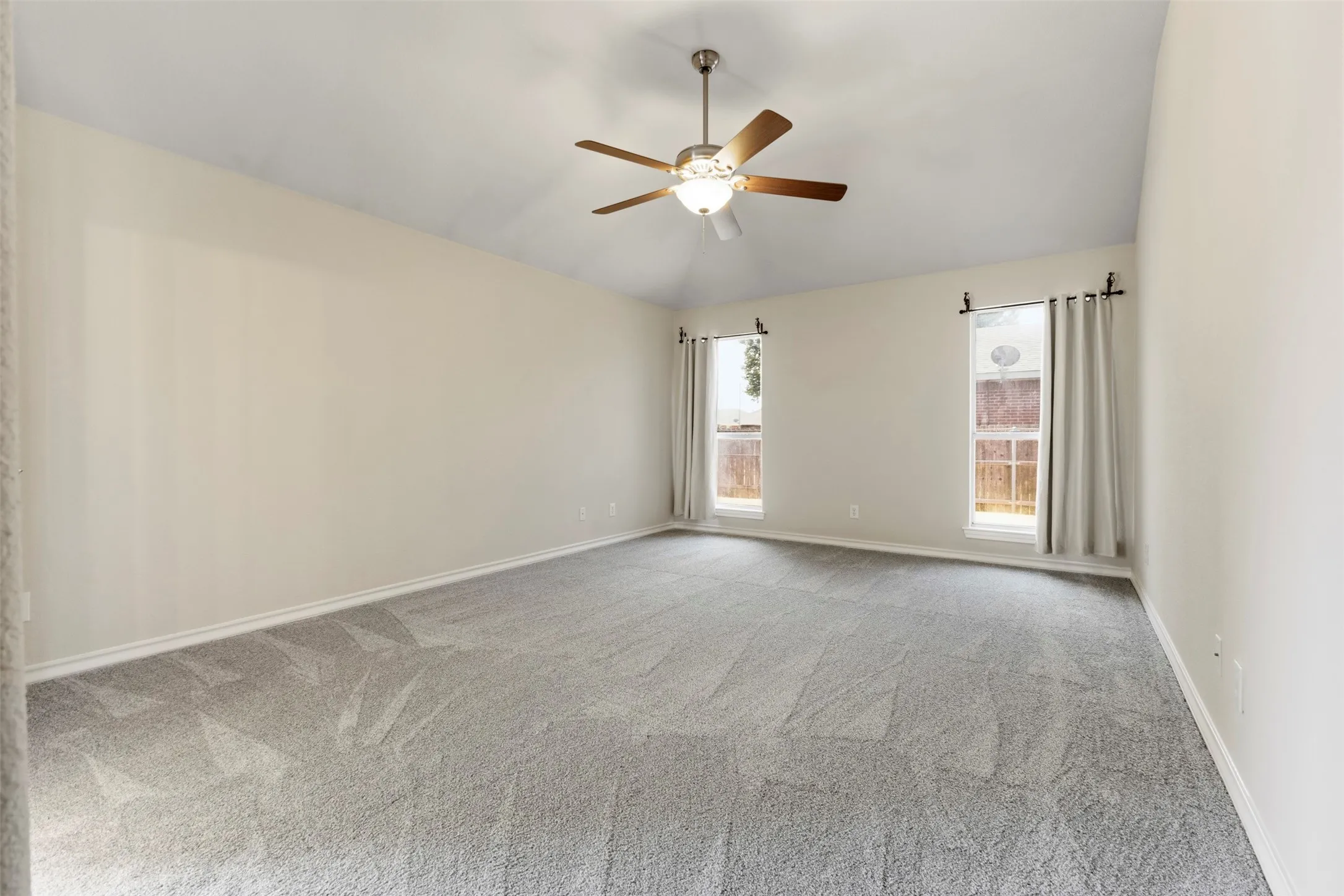 Expansive primary bedroom with brand new carpet and paint.
