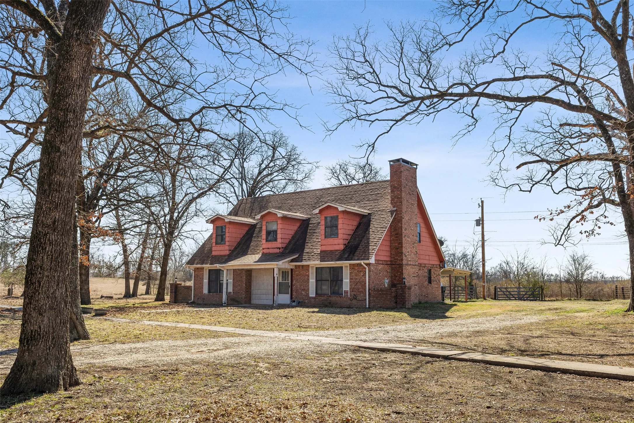 Brick exterior with dormer windows and a prominent chimney