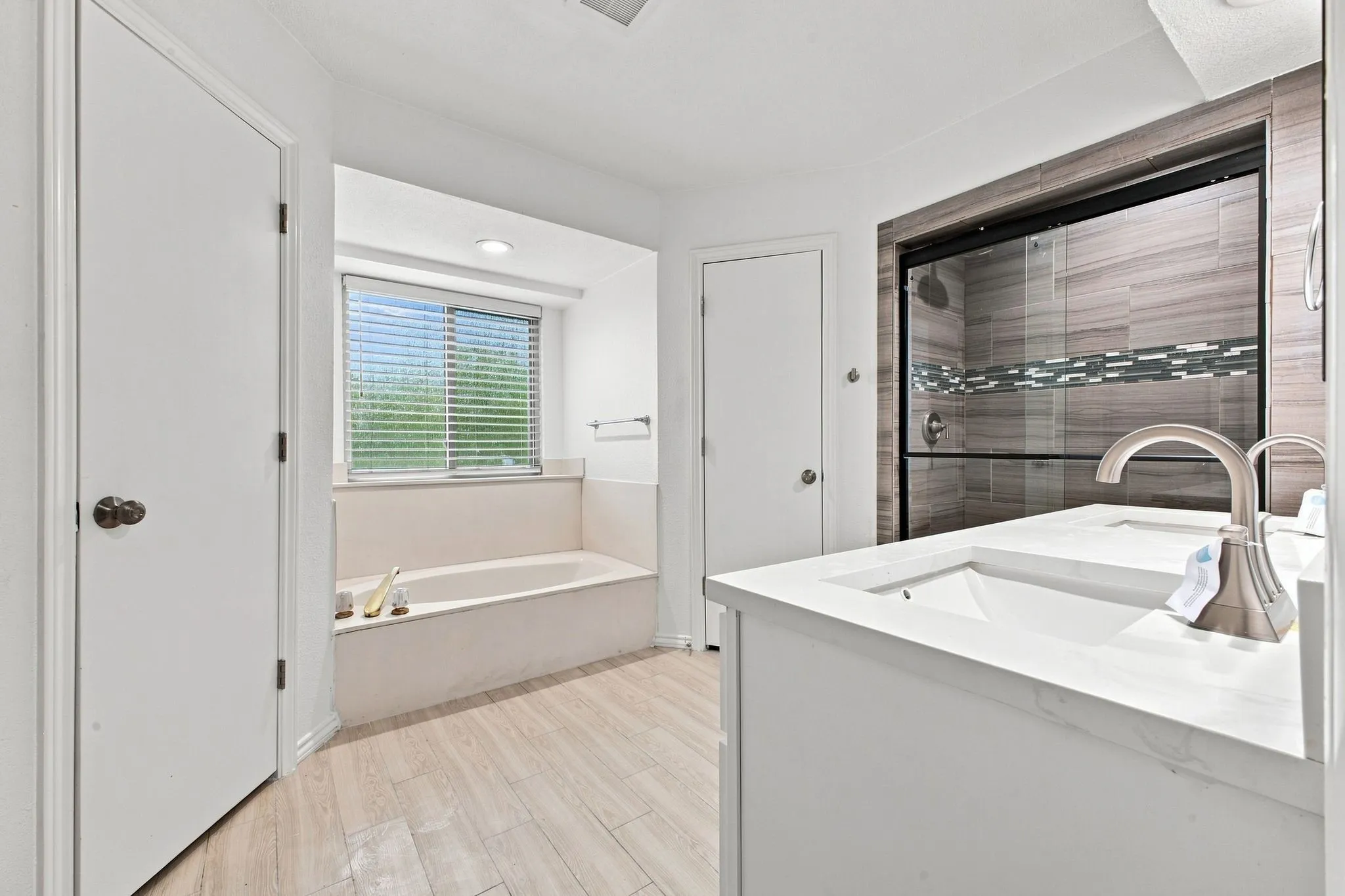 Dual vanity with undermount sinks, quartz countertops, and brushed nickel fixtures