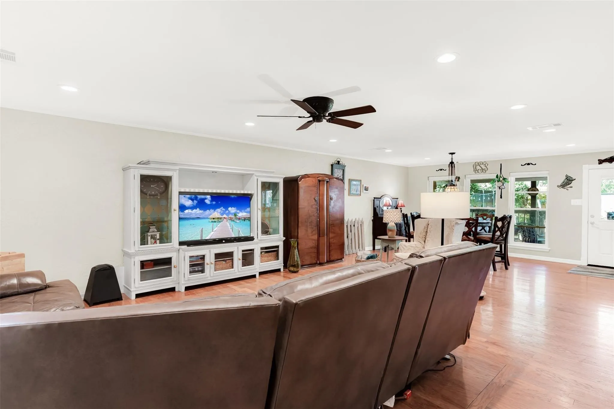Recessed lighting, ceiling fan, wood-finish flooring, white trim, and light-toned walls