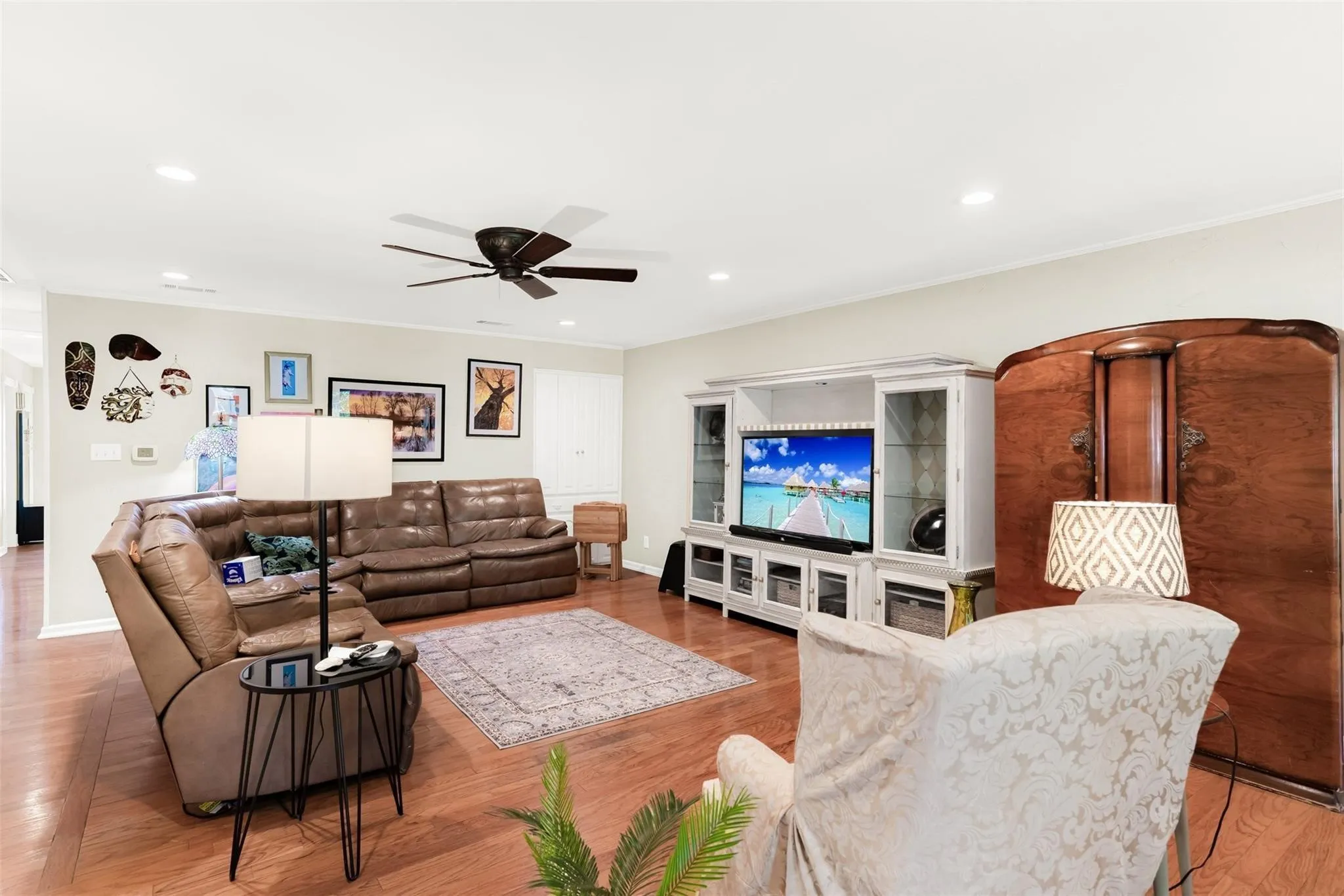 Wood-finish flooring, recessed lighting, and a ceiling fan