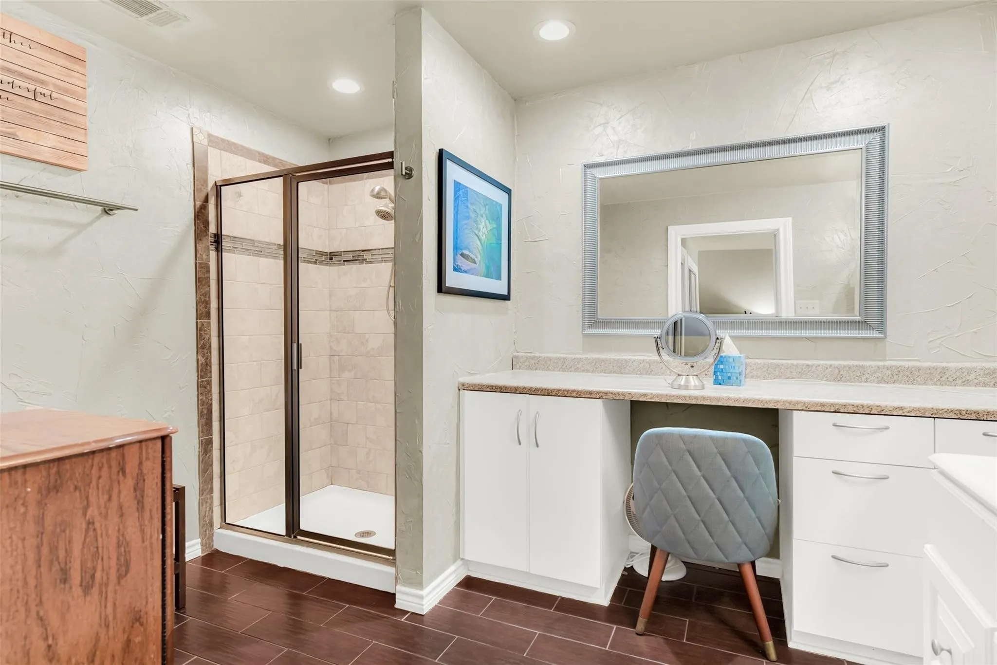 Walk-in shower with tile surround, glass enclosure, and dark bronze-finish frame