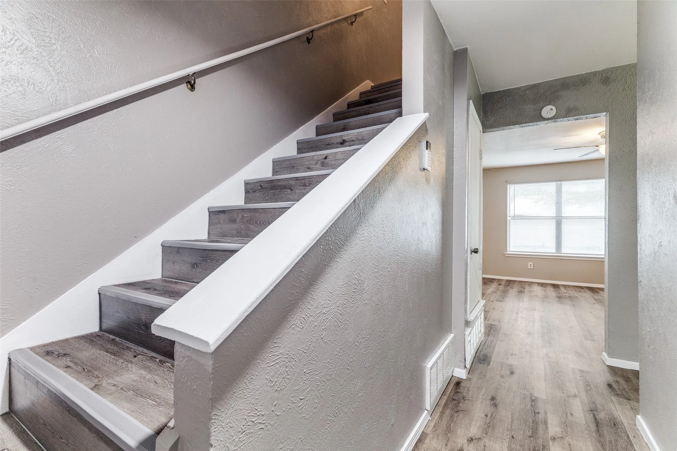Staircase with wood-finish treads and white risers