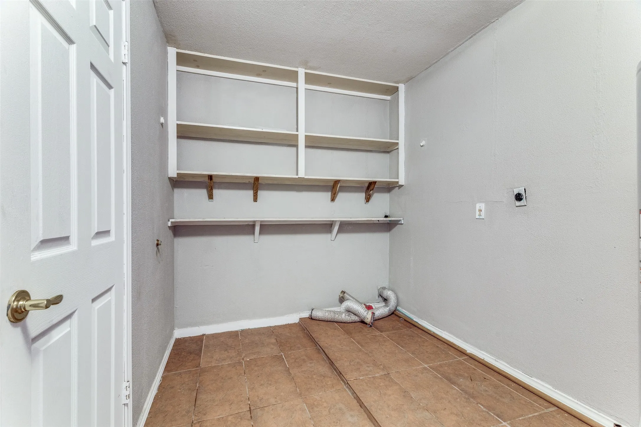 Built-in shelving, durable tile flooring, and utility connections