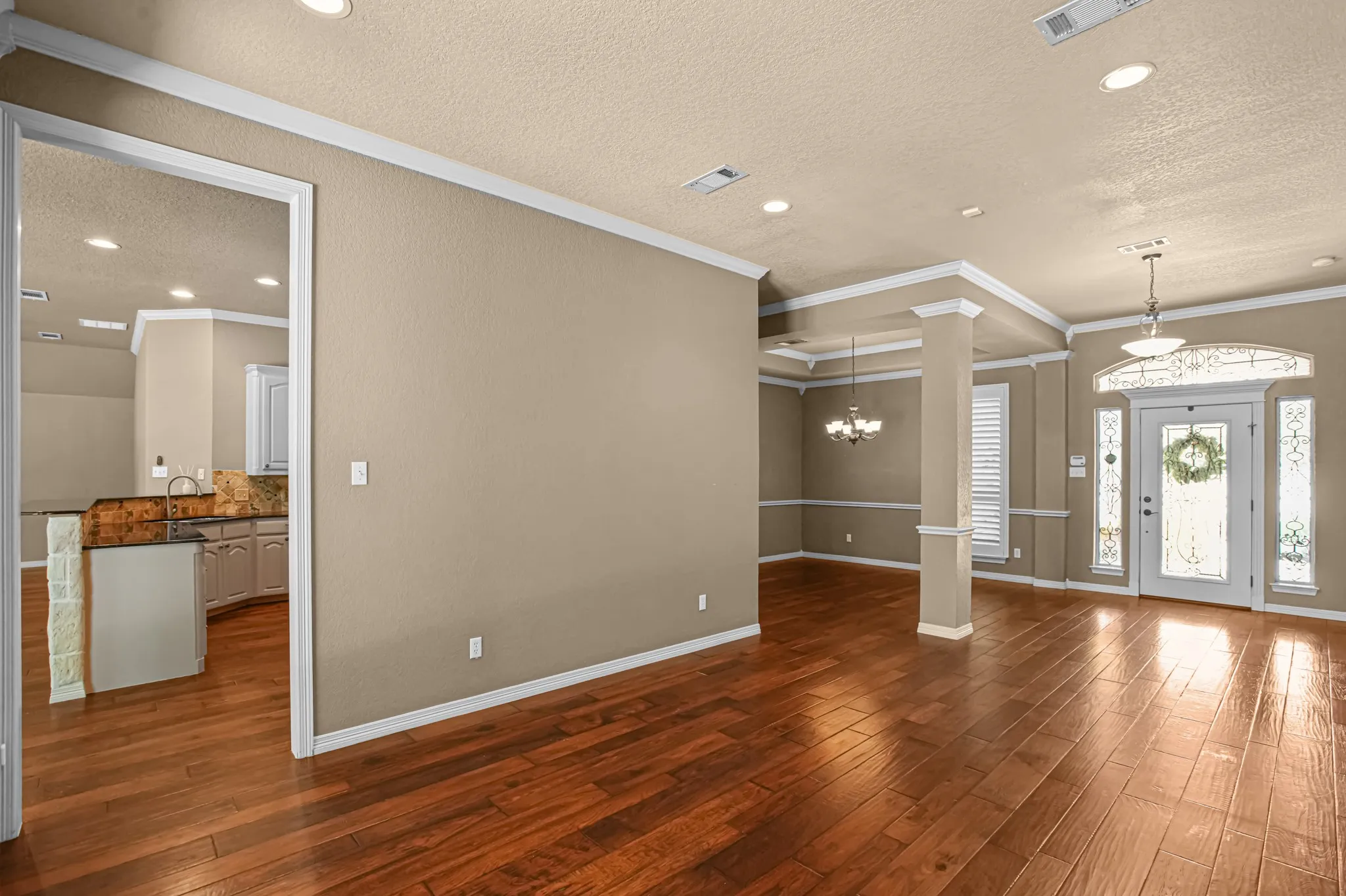 Formal living area with commanding entryway. Light and bright. Please notice recently installed windows throughout.