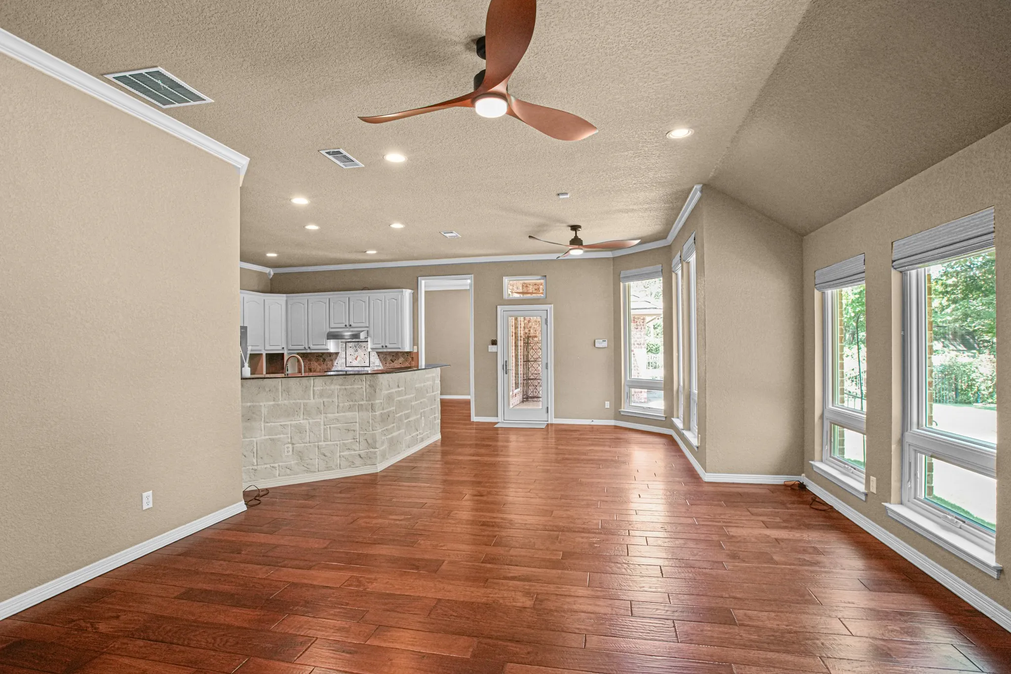 Wood-finish flooring throughout, recessed lighting, and crown molding