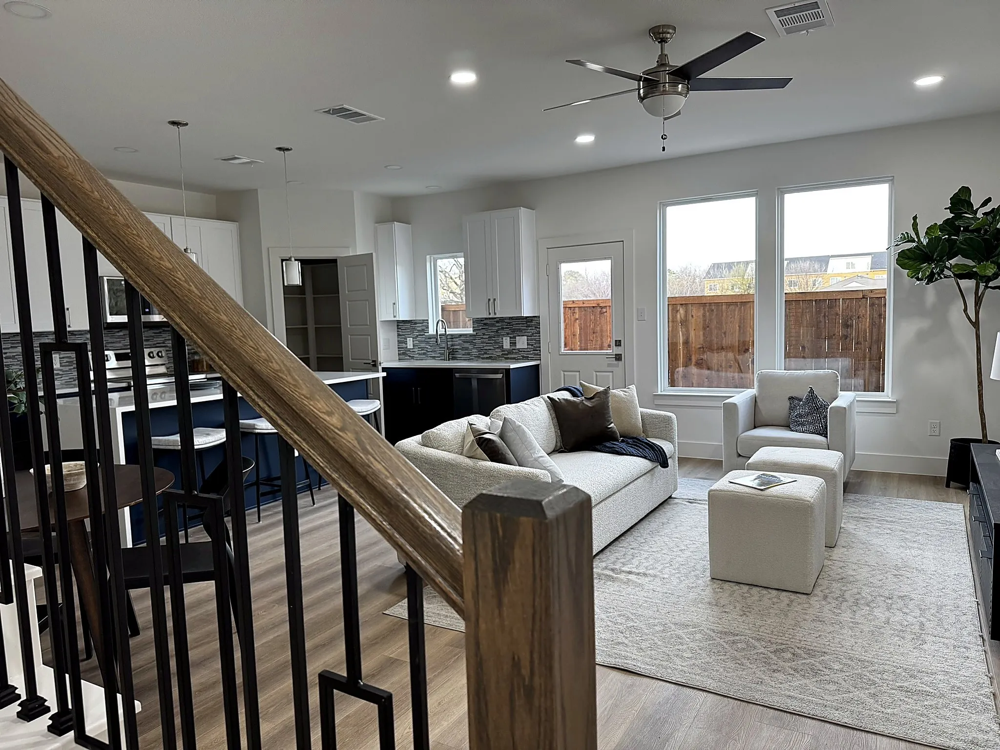 Open-concept living area featuring wood-finish flooring, recessed lighting, and a ceiling fan