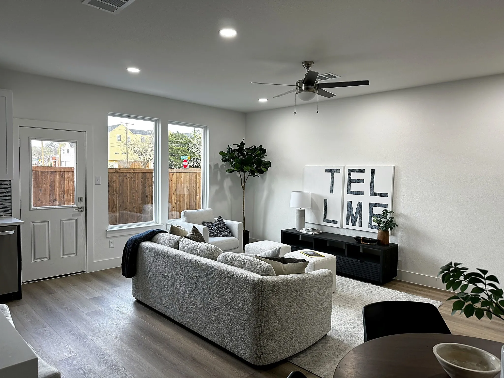 Recessed lighting, wood-finish flooring, ceiling fan, multiple windows, and a glass-paneled exterior door