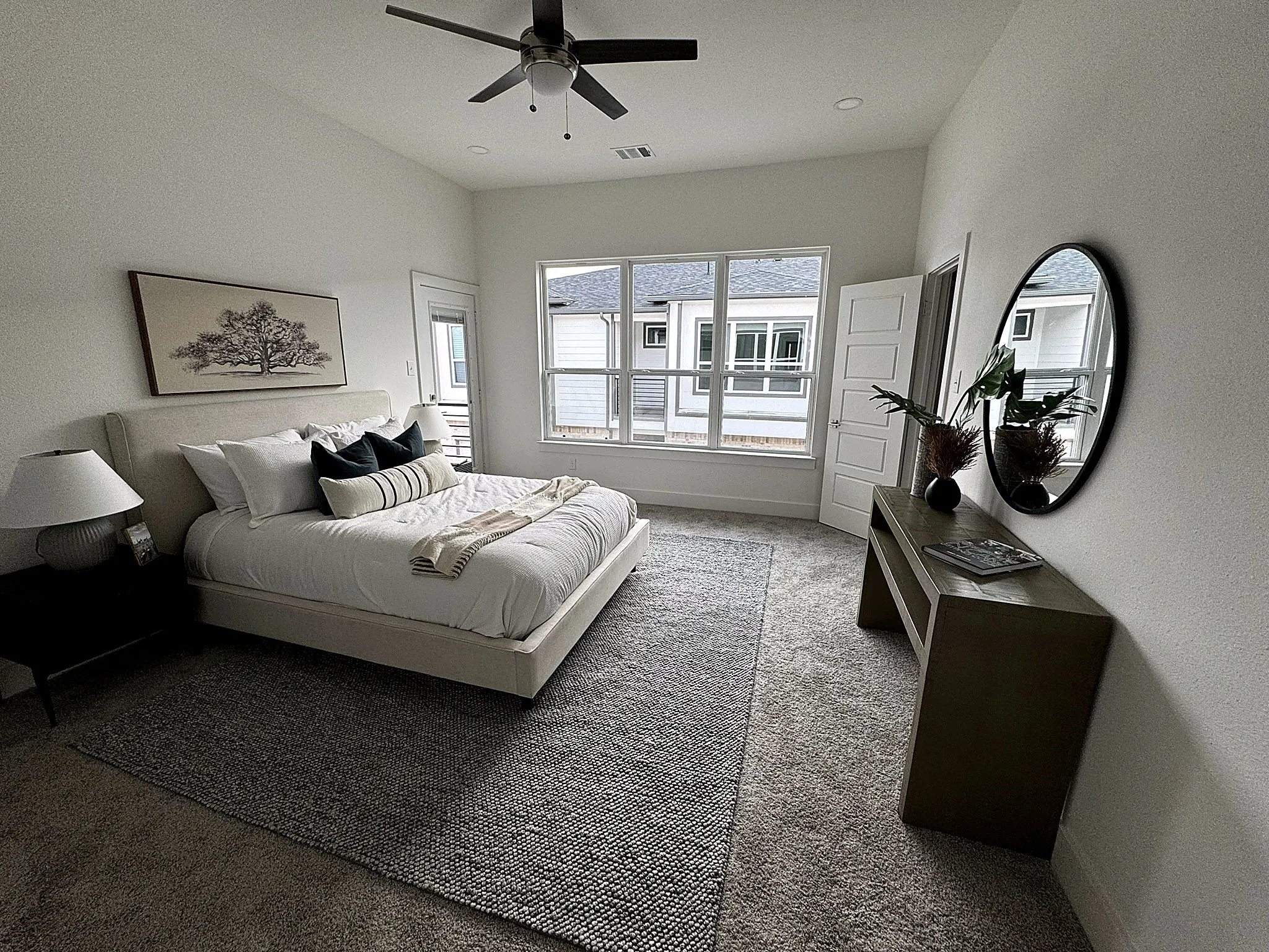 Vaulted ceiling with a ceiling fan, recessed lighting, large windows, and paneled doors