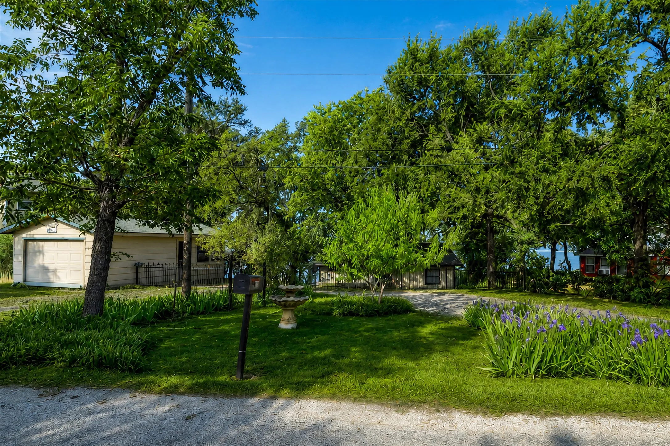 Front yard showing the one car garage with storage.