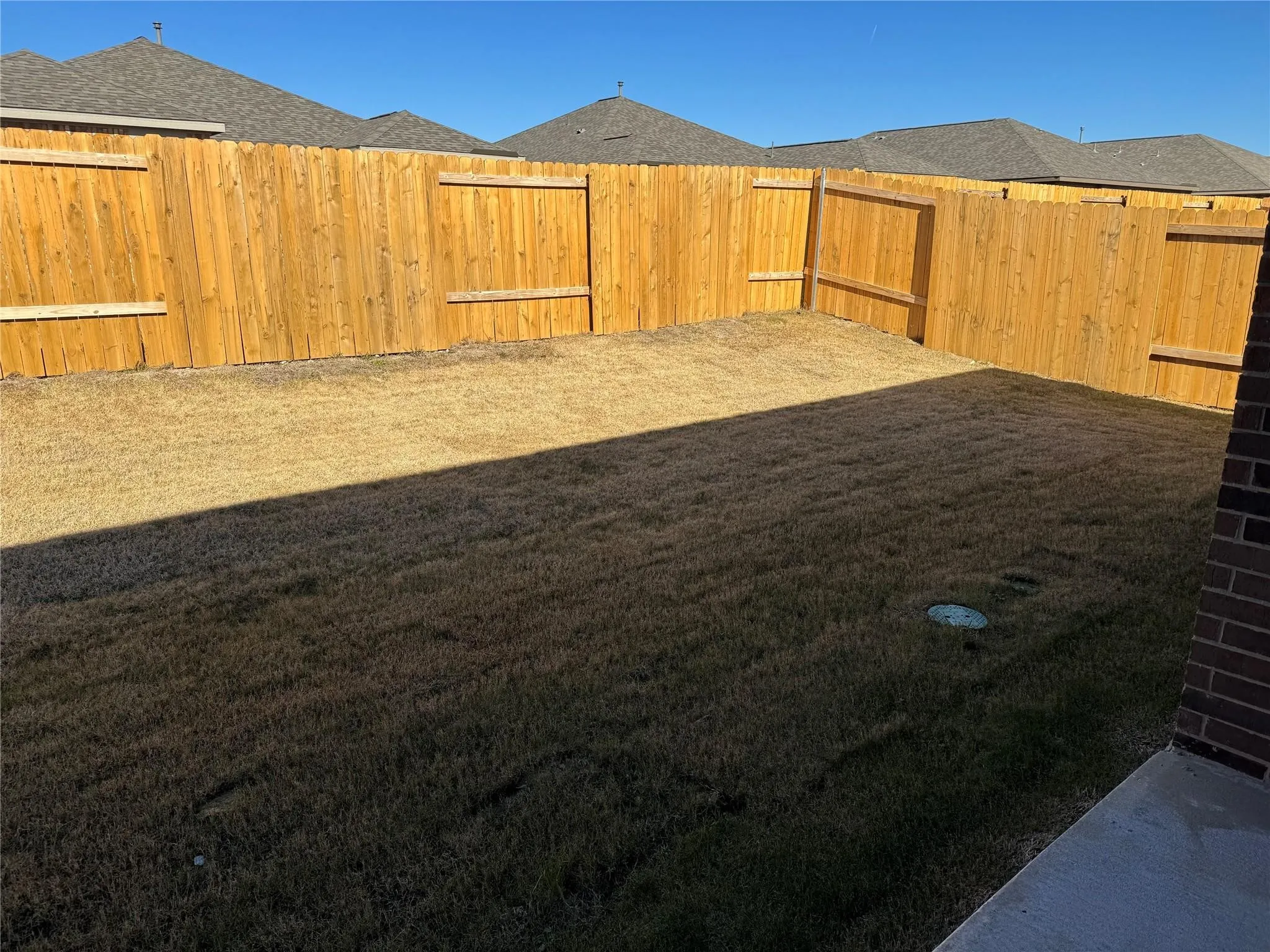 View of fenced backyard