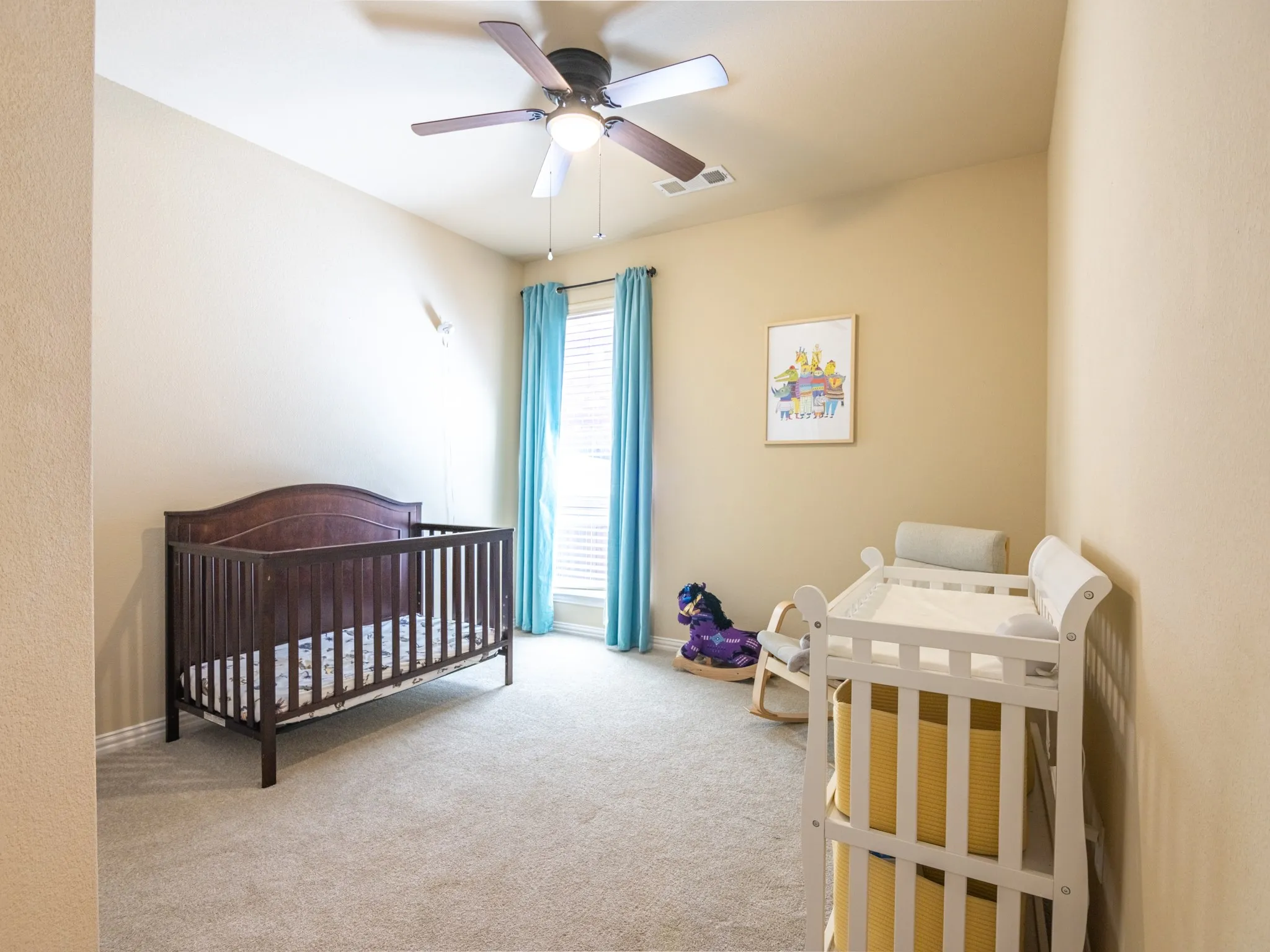 Carpeted room with a ceiling fan, recessed window, and neutral wall tones