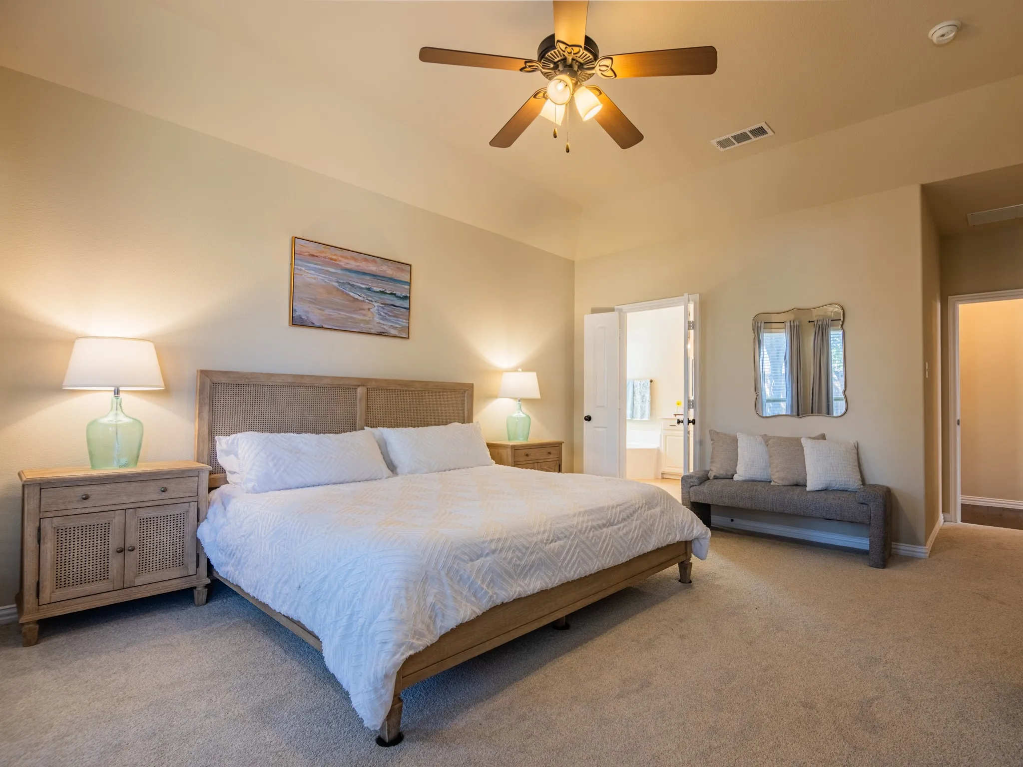 Vaulted ceiling with a ceiling fan, neutral carpet flooring, recessed doorway, and a double-door entryway