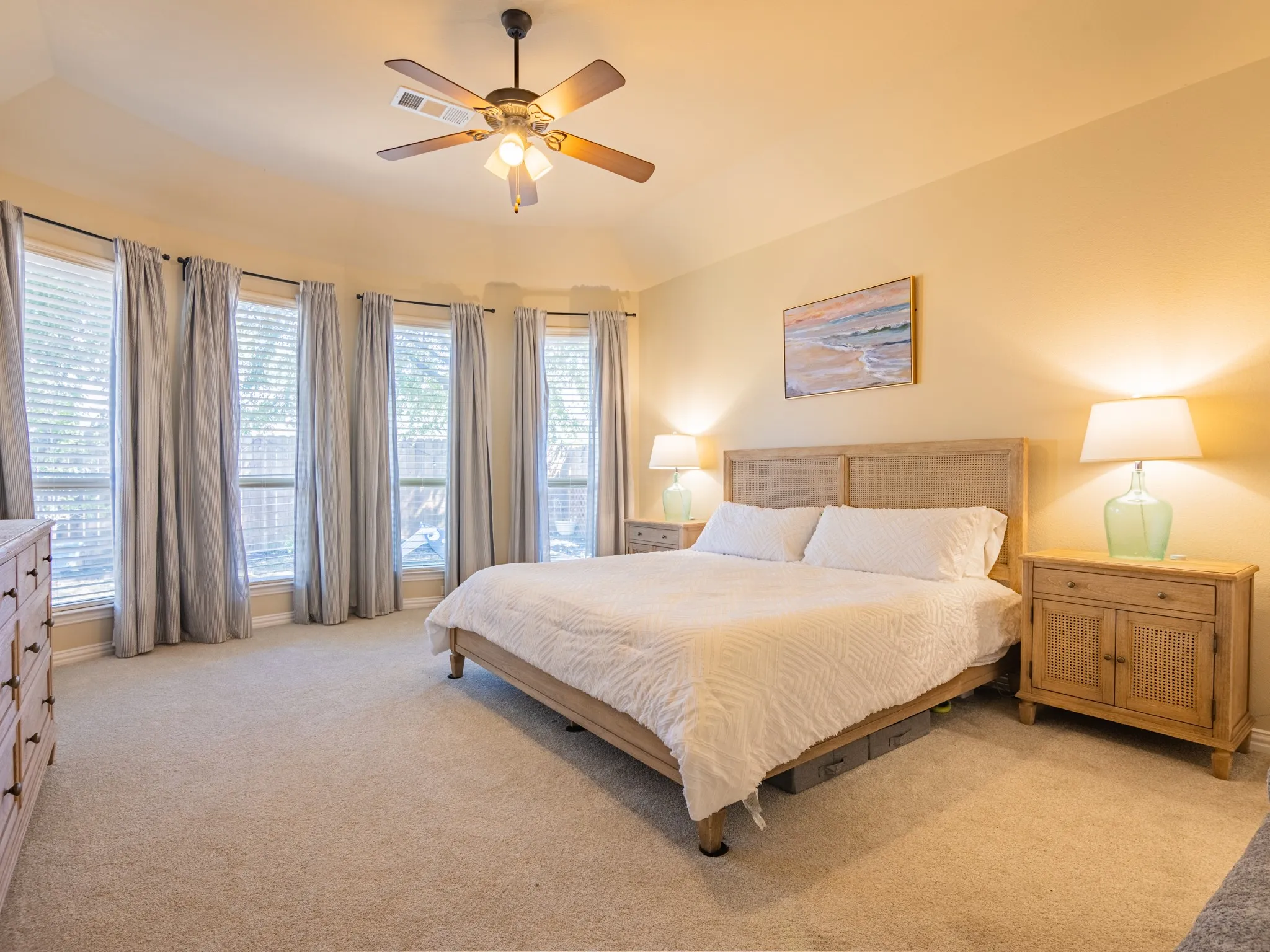 Recessed ceiling, ceiling fan, carpeting, multiple windows, window blinds