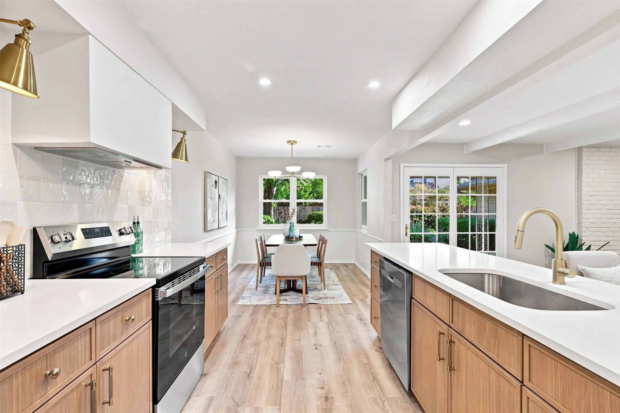 Kitchen with wood-finish cabinetry, white countertops, a stainless steel range, and a dishwasher