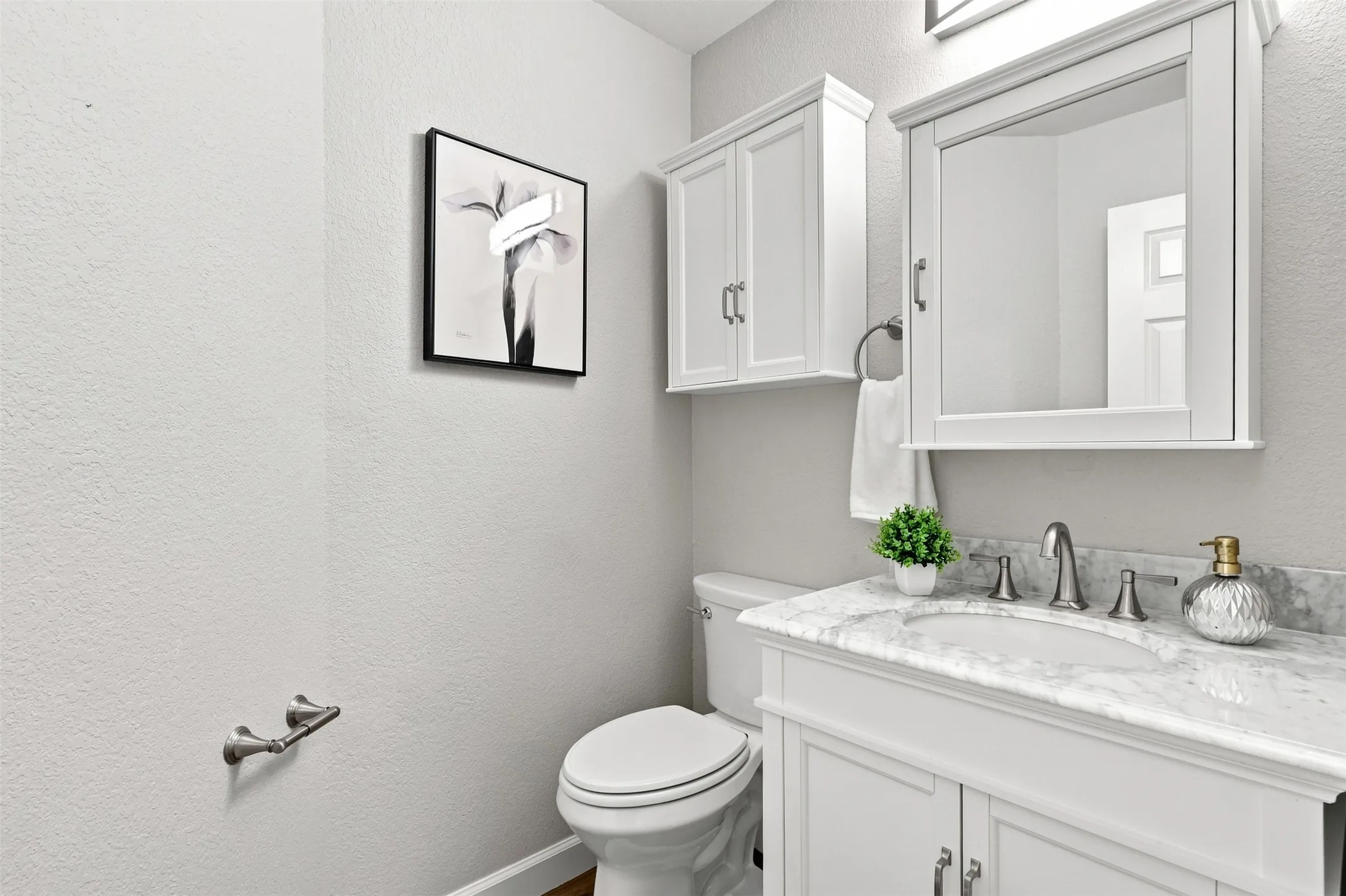 Half bathroom with vanity is perfect for guests.