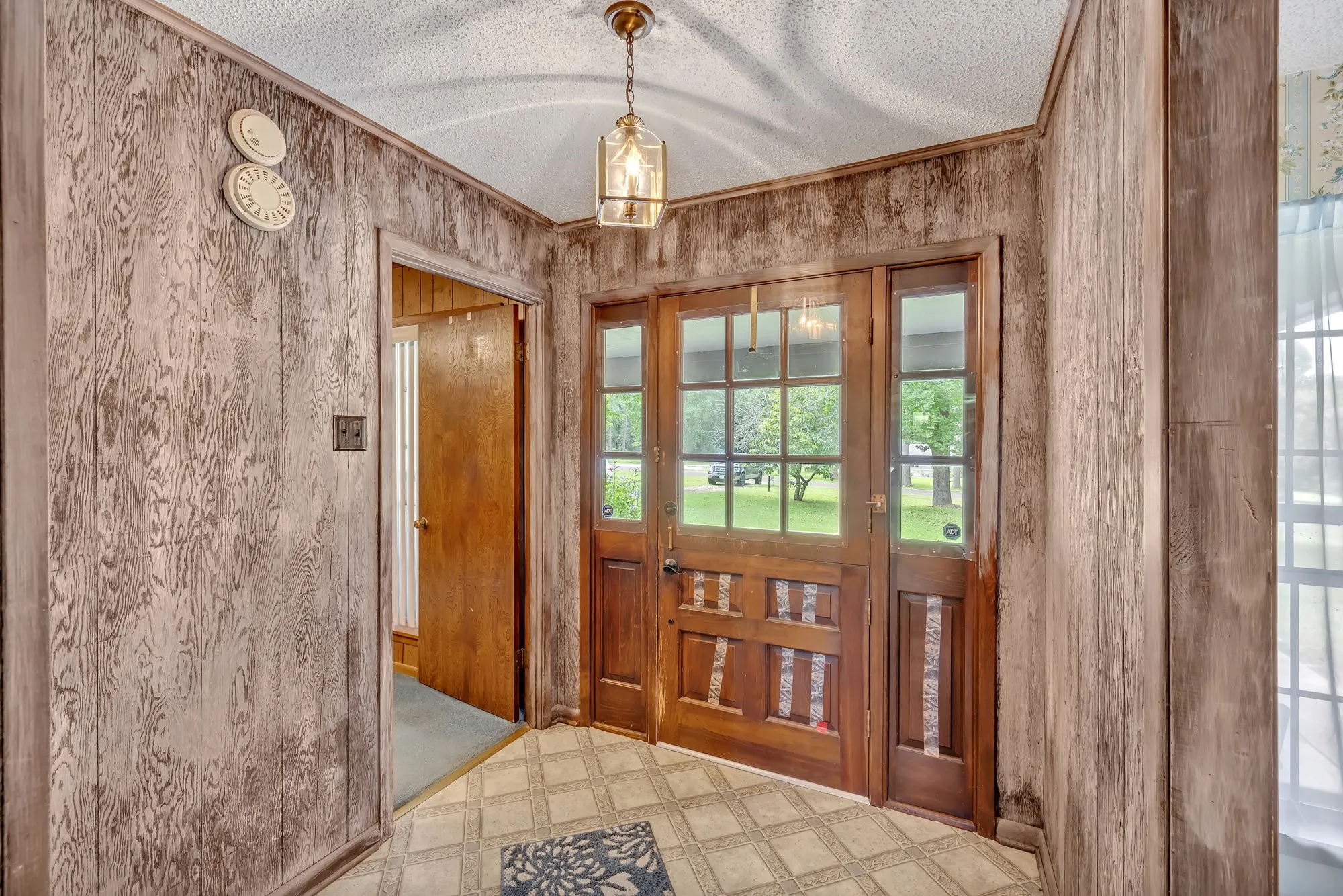 Wood-paneled walls with a textured ceiling