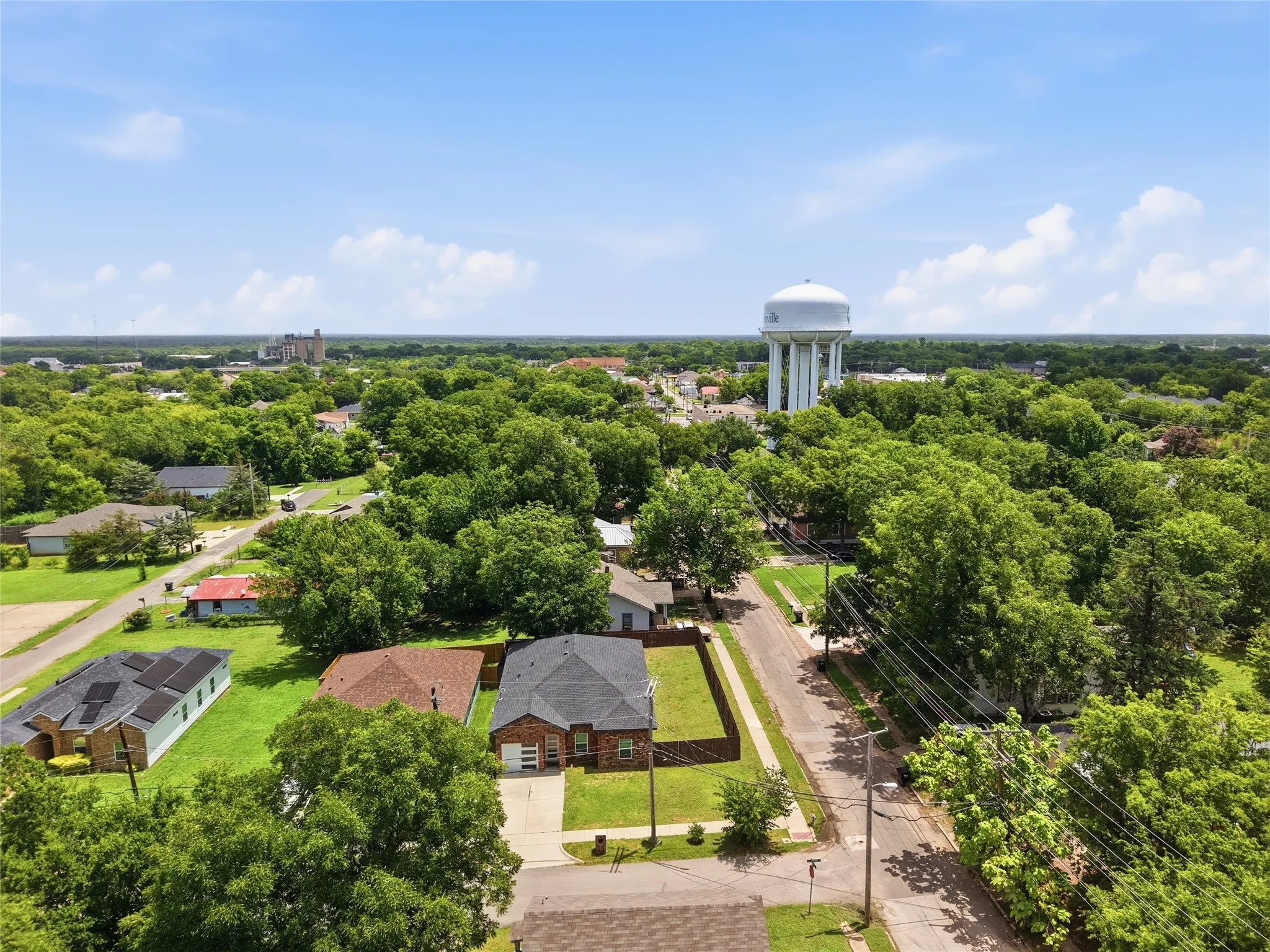Aerial perspective showcasing a residential neighborhood with mature trees