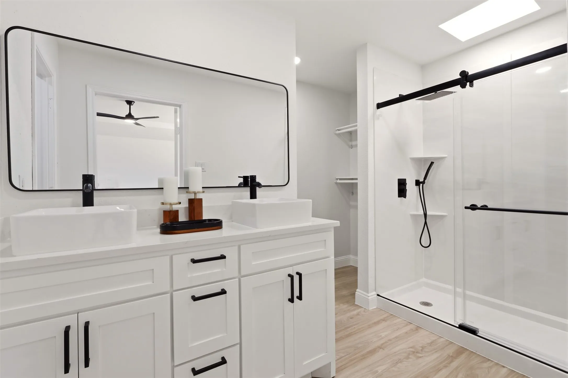 Dual vanity with vessel sinks, white cabinetry, and matte black fixtures