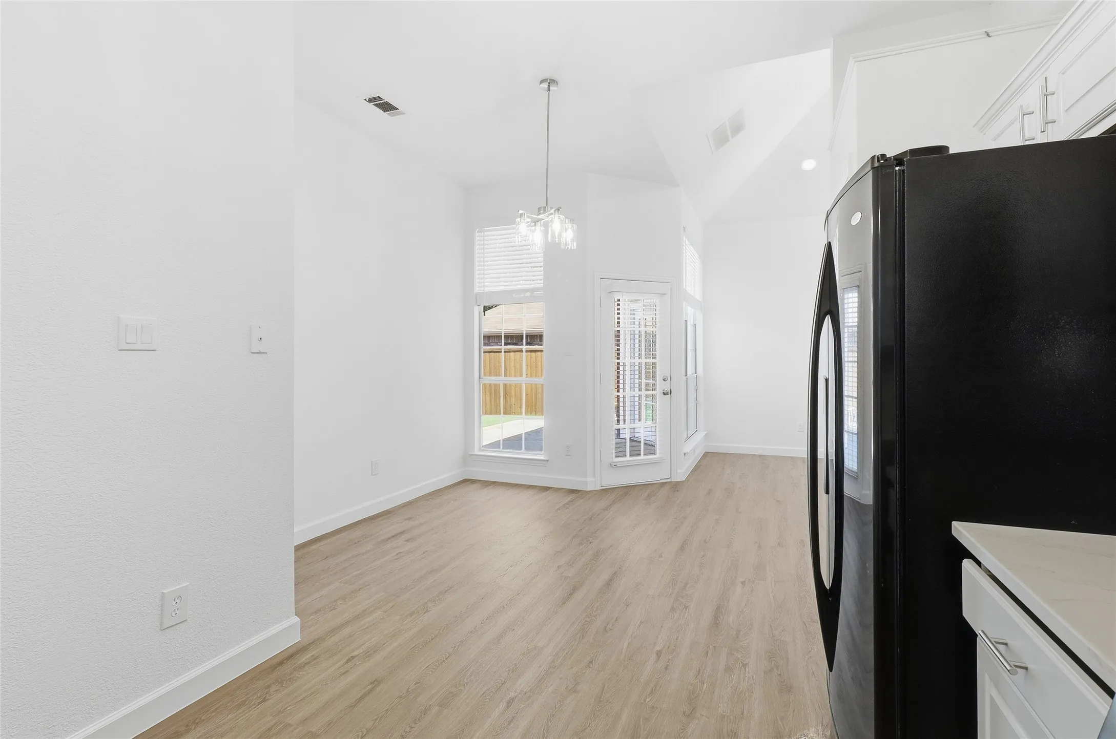 Dining with window to patio and open to kitchen