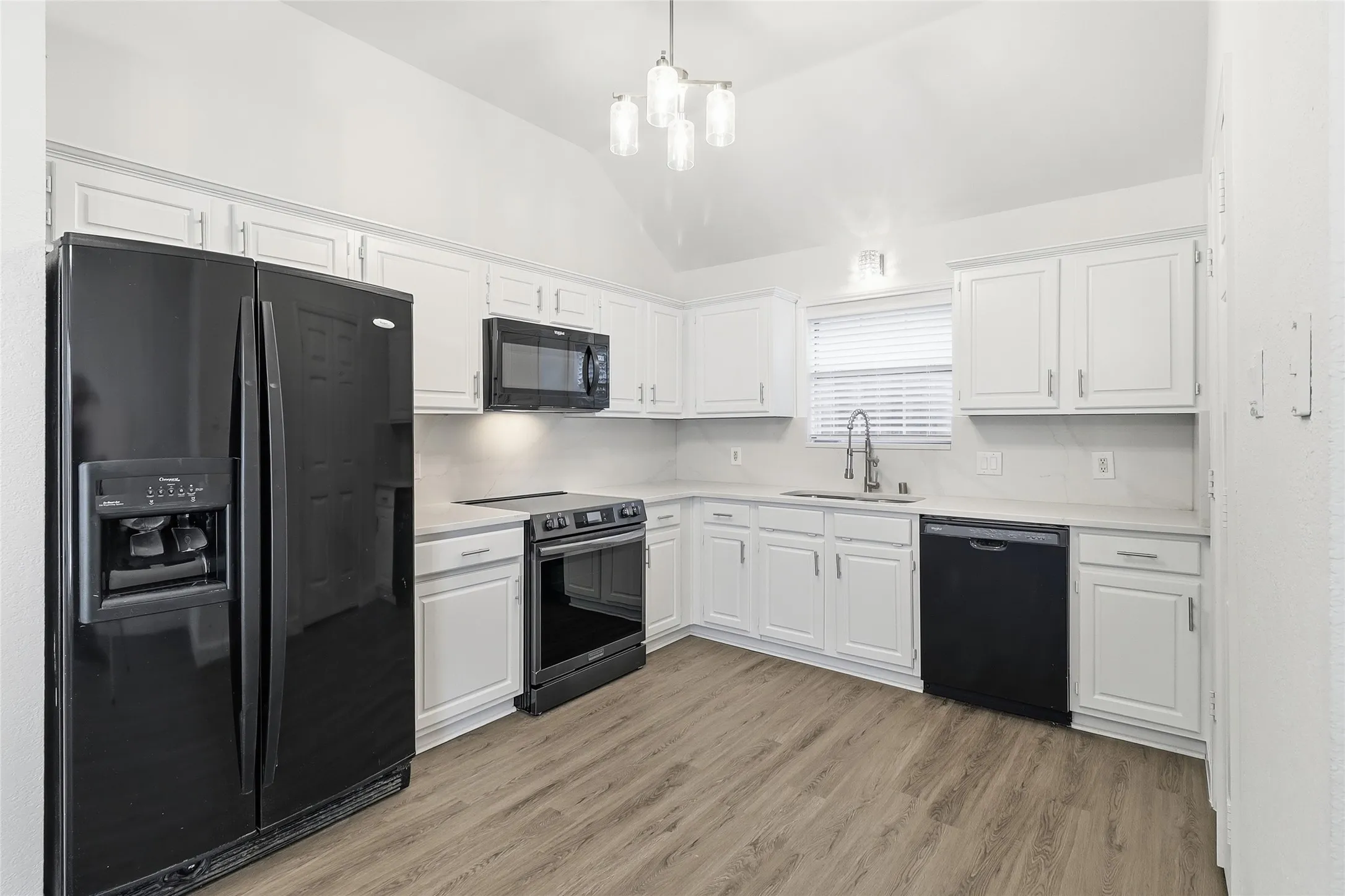 Refrigerator, self-clean range and quartz counter tops