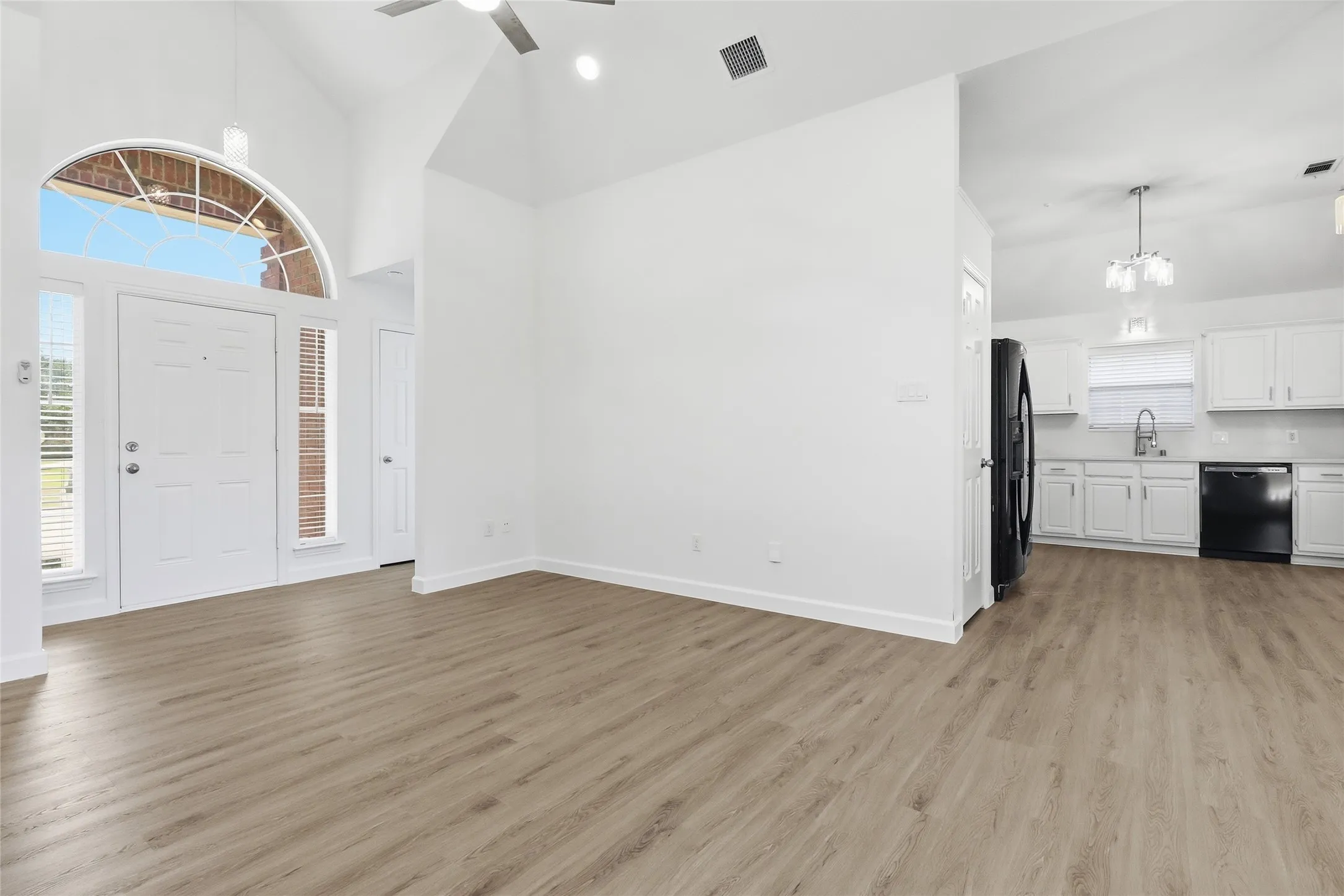 Entry with archway and all open to kitchen