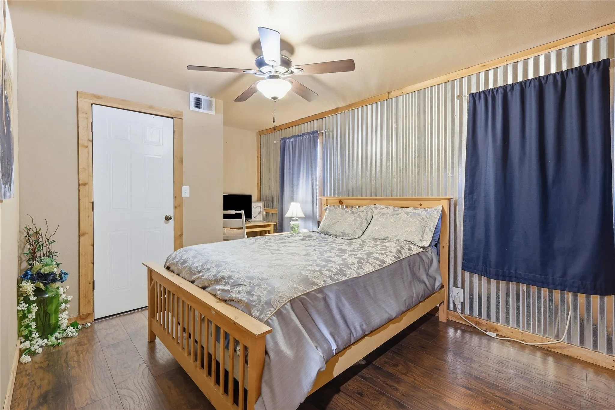 Wood-finish flooring with a white paneled door