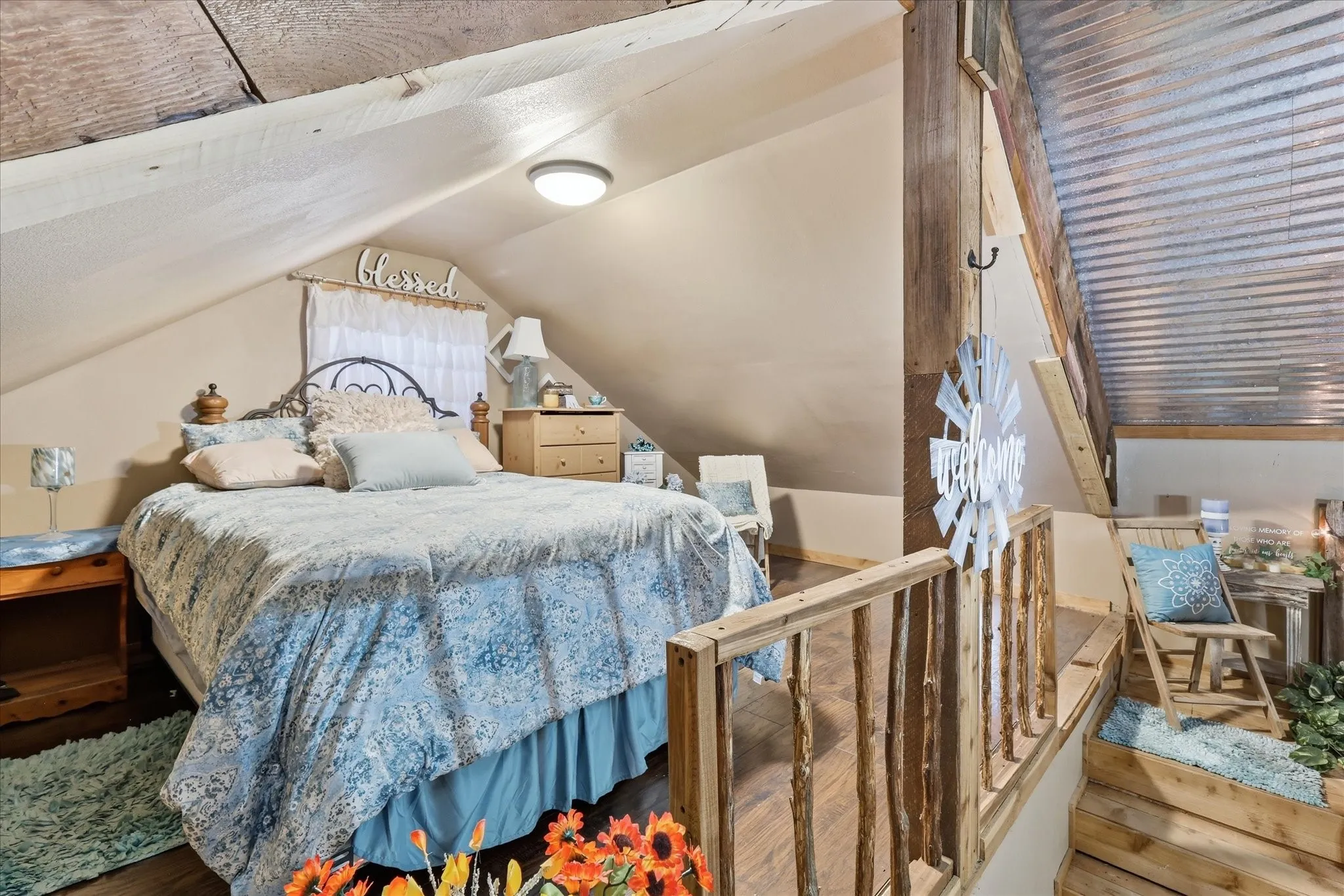 Wood-finish flooring, exposed wood beams, and a corrugated metal ceiling