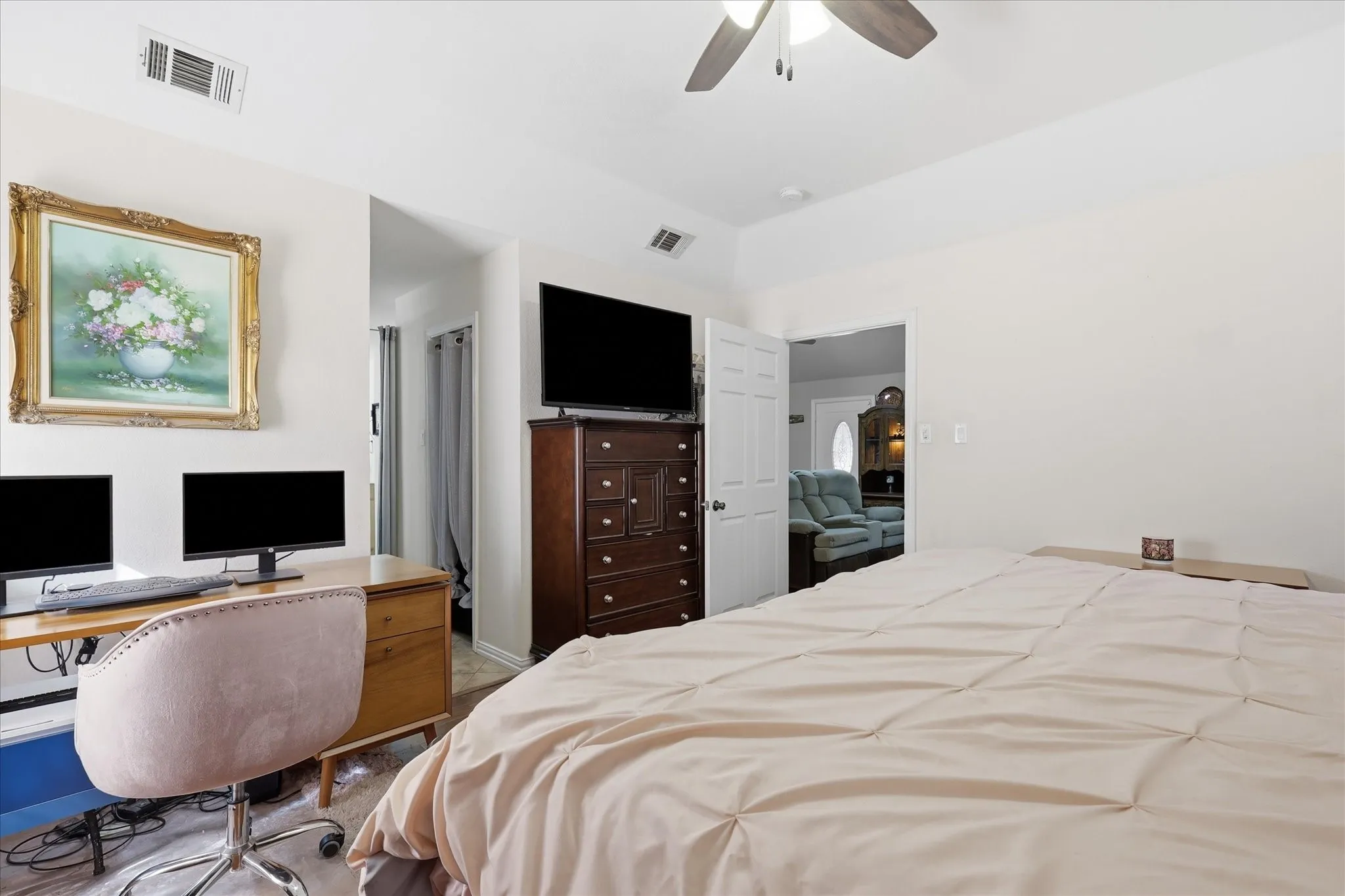 Recessed ceiling, ceiling fan, wood-finish flooring, white walls, and an open doorway
