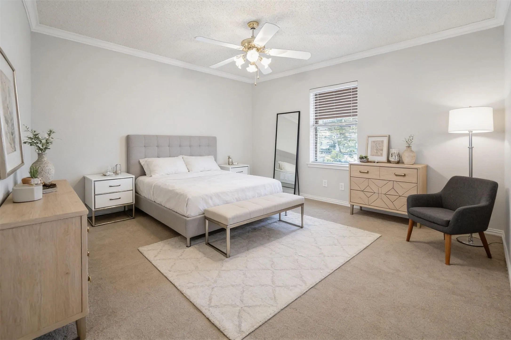 Carpeted room featuring crown molding, a ceiling fan with light, and a window with blinds