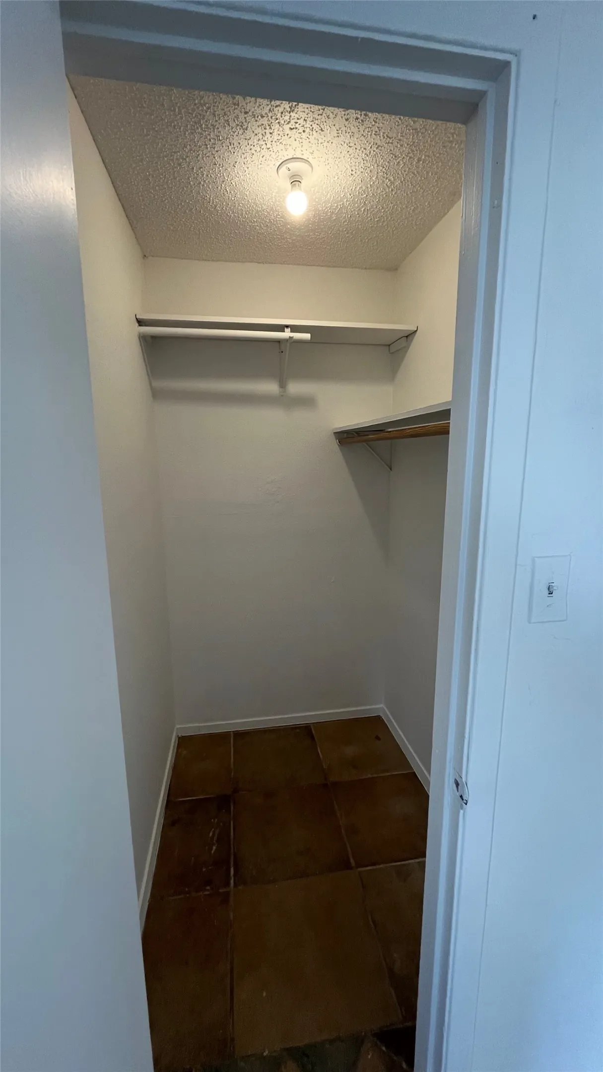 Bedroom 3 -  Walk-In Closet Integrated overhead lighting, built-in shelving, and tile flooring