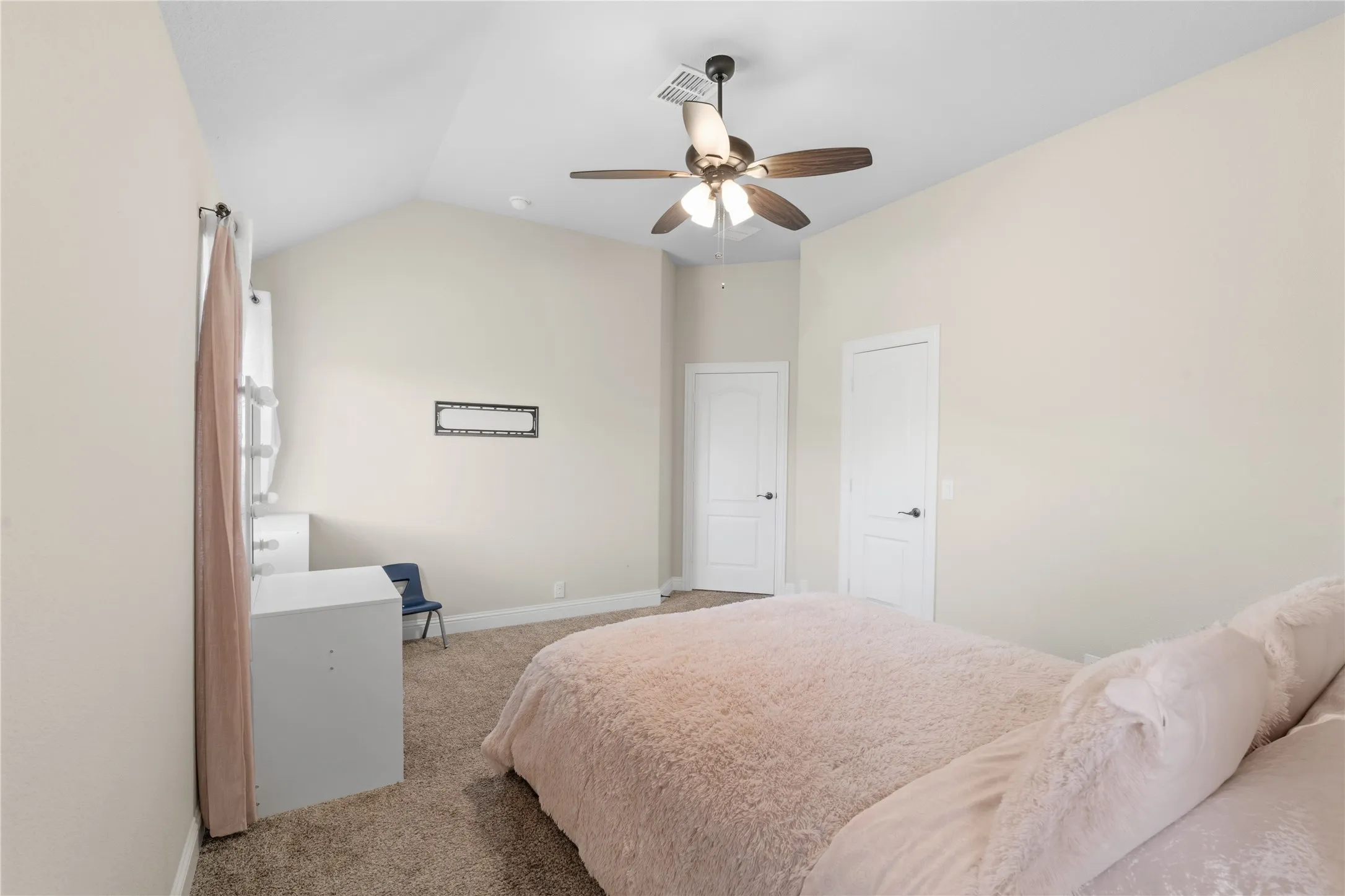 Bedroom featuring carpet, lofted ceiling, and ceiling fan
