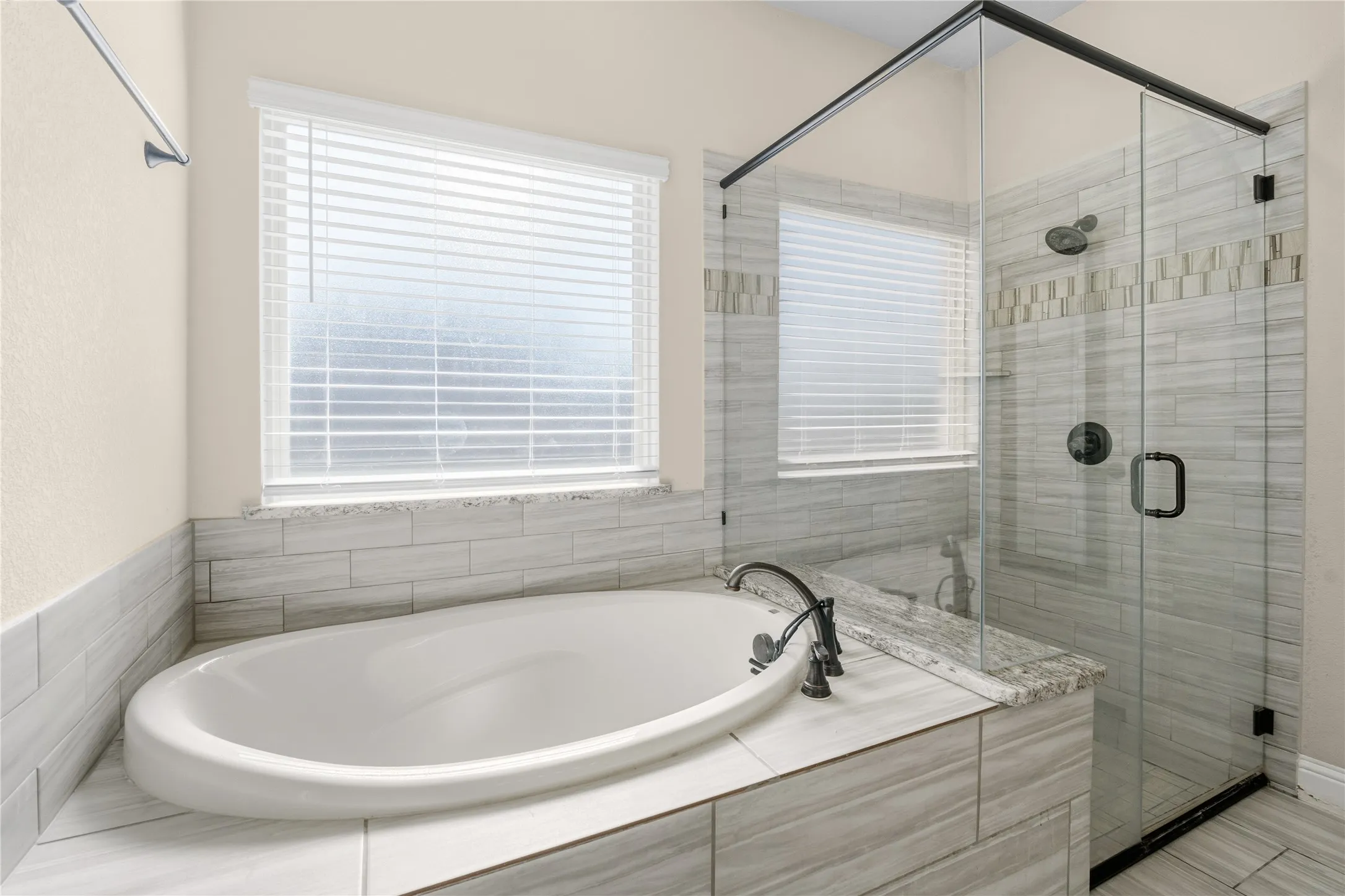 Full bathroom with a stall shower and a bath