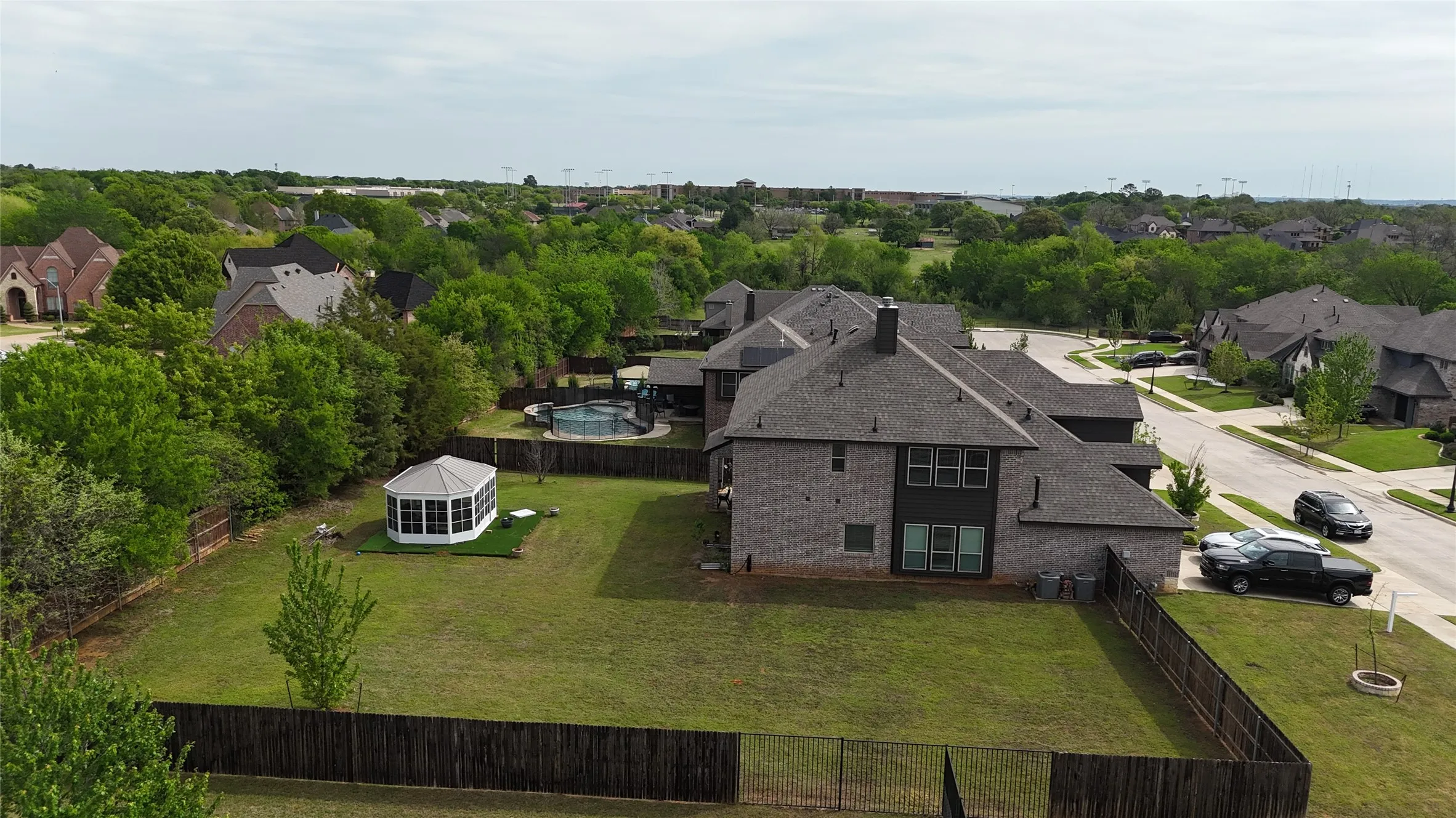 Aerial view of residential area featuring a tree filled landscape