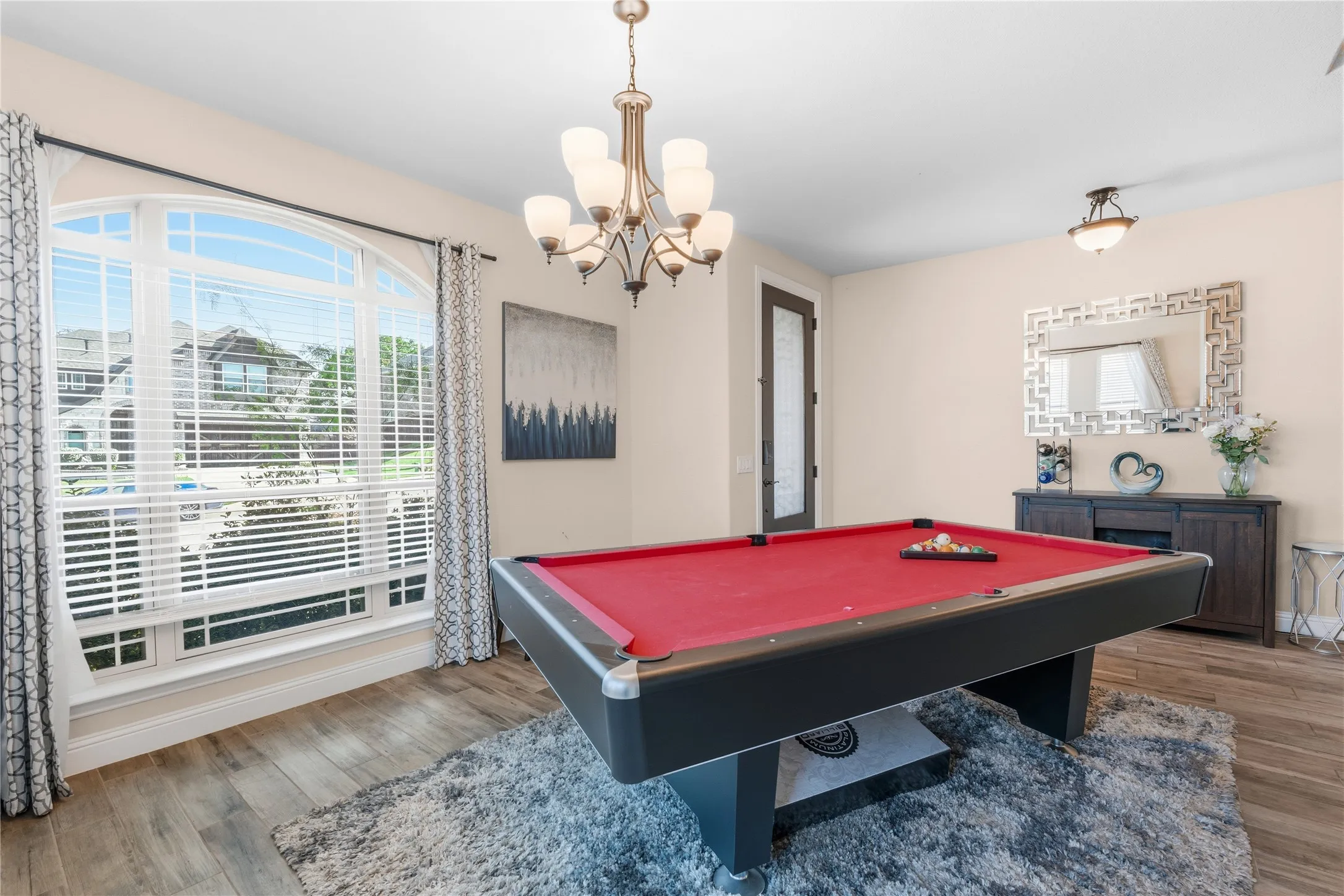 Playroom with light wood-style floors, billiards, healthy amount of natural light, and hanging lights