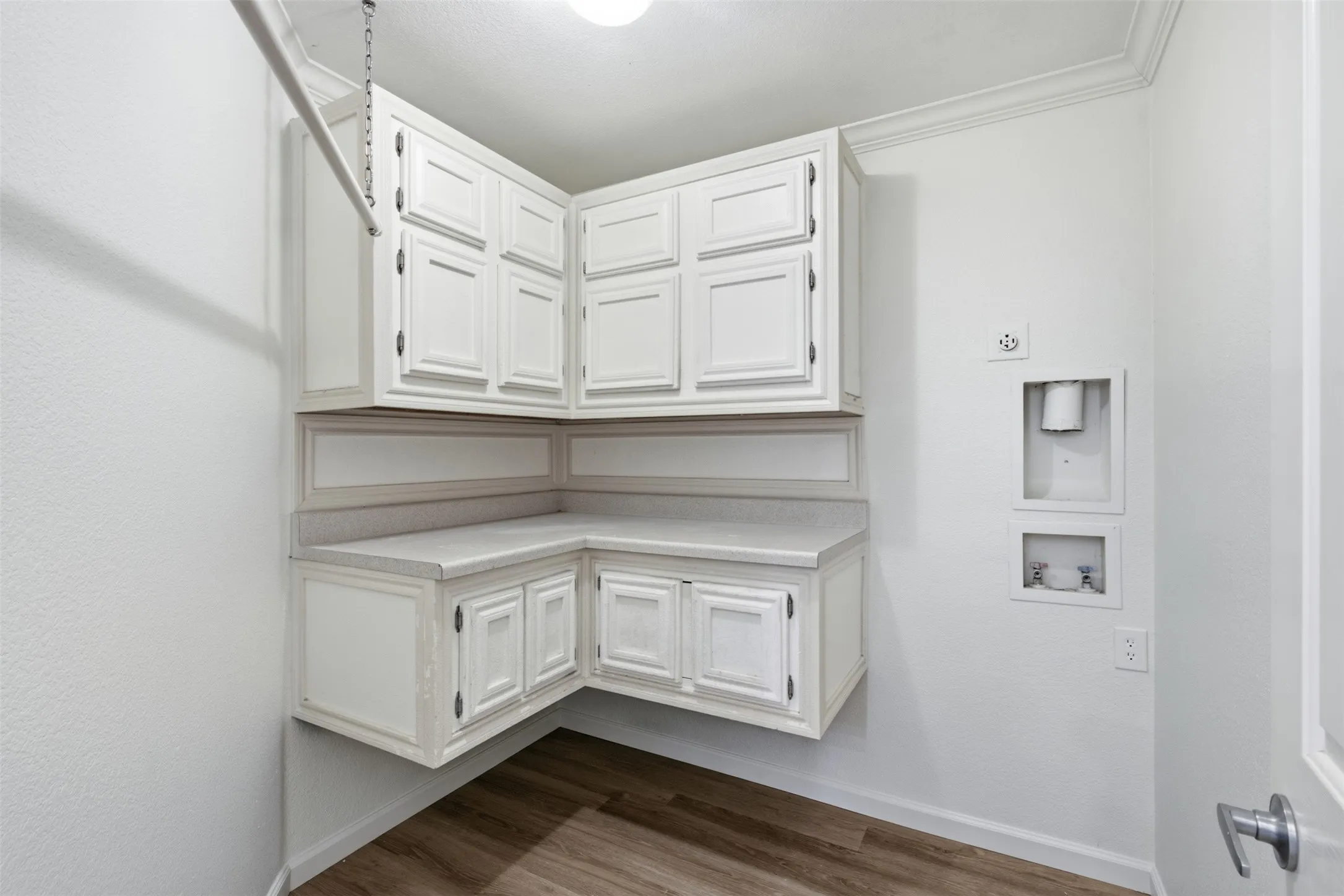 Large laundry with hanging area, built-in cabinets and area for stackable washer and  dryer at 10232 Ash Creek Lane by Seth Fowler of Williams Trew Real Estate